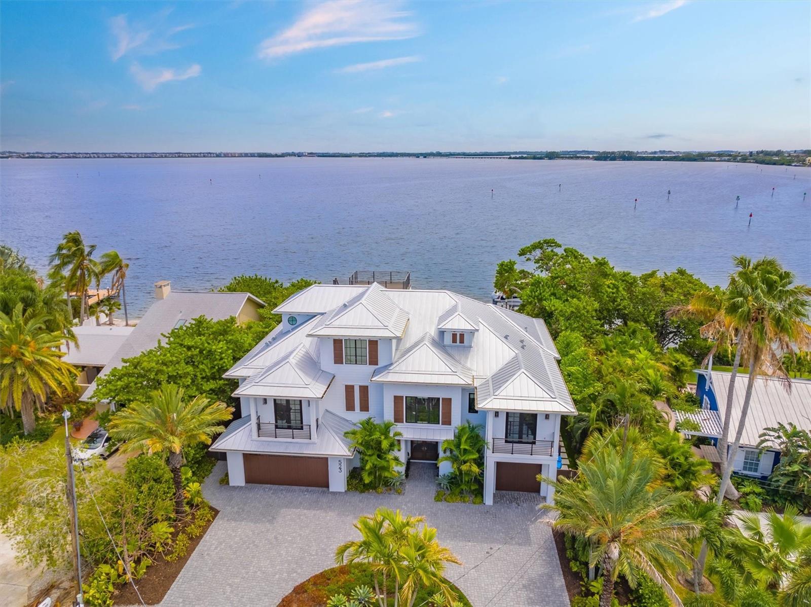 Welcome to your coastal paradise on Anna Maria Island! This stunning direct bay front 4-bedroom, 4.5-bathroom residence at 523 56th Street offers the epitome of island living, with luxurious features and breathtaking views.
As you step inside, you'll be greeted by an open and inviting floor plan, filled with an abundance of natural light. The spacious living area is perfect for both relaxation and entertaining, and it seamlessly flows into a gourmet kitchen equipped with top-of-the-line appliances, perfect for culinary enthusiasts.
This home also boasts a dedicated office space, allowing you to work from the comfort of your island retreat. With 4 generously sized bedrooms, including a master suite that exudes elegance and comfort, there's room for family and guests to enjoy their own private spaces.
One of the standout features of this home is the rooftop deck, where you can savor stunning sunsets, entertain under the stars, or simply unwind with panoramic views. The private elevator adds convenience, making access to all levels effortless.
Step outside to discover your own tropical oasis, complete with a pool and spa, full outdoor kitchen and bar that are surrounded by lush landscaping, creating a serene atmosphere for relaxation and outdoor gatherings.
Private dock with deep water boat, 24,000 lb boat lift & 2 jet-ski lifts.
Located within walking distance to the pristine beaches of Anna Maria Island, this property offers the perfect blend of tranquility and convenience. Whether you're seeking a permanent residence, a vacation getaway, or an investment opportunity, 523 56th Street awaits, promising a lifetime of cherished memories in paradise. This home is offered fully furnished with elegant decor and artwork included.
Don't miss the chance to make this dream home yours—schedule your private showing today!