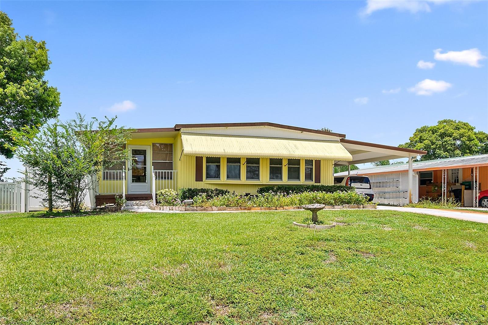 OPEN HOUSE, JULY 27TH, 2 to 4. Charming 2 bedroom, 2 bath home, located in the sought-after 55+ neighborhood of Laurelwood. NO LOT RENT - you own the land. Brand new floors in the main areas and main bathroom. New roof in 2018, new A/C around two years ago. The Florida room can be used as an office, craft room, or for whatever your needs are. Large deck off the back, overlooking a beautiful and private, fully-fenced back yard. This tight-knit community has a fantastic location, close to dining, doctors, groceries, gas, etc. Very common to see homeowners on golf carts, bicycling or walking their dogs. Just a lovely place to call home.