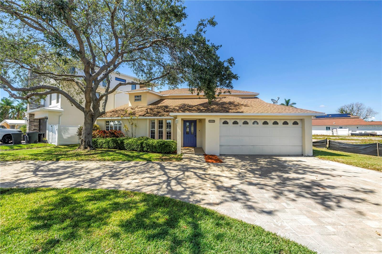 Welcome to your elegant coastal retreat — a superbly updated 4-bedroom, 4-bathroom home on a coveted corner lot, just a short stroll or bike ride from the lovely shores of Redington Beach.
From the moment you arrive, the appealing circular driveway and manicured landscaping set the tone for this luxury home. Inside, you’ll find high-quality materials and posh finishes throughout, including brand-new marble countertops, top-of-the-line appliances, and thoughtfully appointed spaces that truly make this residence shine.
The main level welcomes you with gorgeous water views as soon as you step inside, and features a generously sized living room, a formal dining room, and a welcoming sitting area that can also double as a dining room just off the gourmet kitchen, complete with stylish barstool seating — perfect for everyday meals or entertaining. A convenient, expansive laundry room with storage and a sink off the kitchen adds everyday ease.
The main floor offers two bedrooms and two bathrooms — one of which is an en-suite — each with elegant finishes, while the second level is the pinnacle of comfort with two additional en-suite bedrooms and two bathrooms, including an expansive owners’ suite that’s the ultimate retreat. Enjoy spanning water views, double vanities, a luxurious rain head shower, and a soaking tub with serene water views. Two spacious walk-in closets add to the suite’s superb appeal.
Step outside through your private door to a large balcony, also accessible from the second upstairs bedroom, and take in the gorgeous views — perfect for morning coffee or sunset unwinding.
For those who love boating, this property also features a dock, offering the ideal spot to launch into the open water and enjoy waterfront living to the fullest.
The home is beautifully appointed for outdoor entertaining too — with a covered grill area and that unbeatable proximity to the beach.
Every detail reflects the pinnacle of coastal luxury, ready to welcome you home to your own slice of paradise.