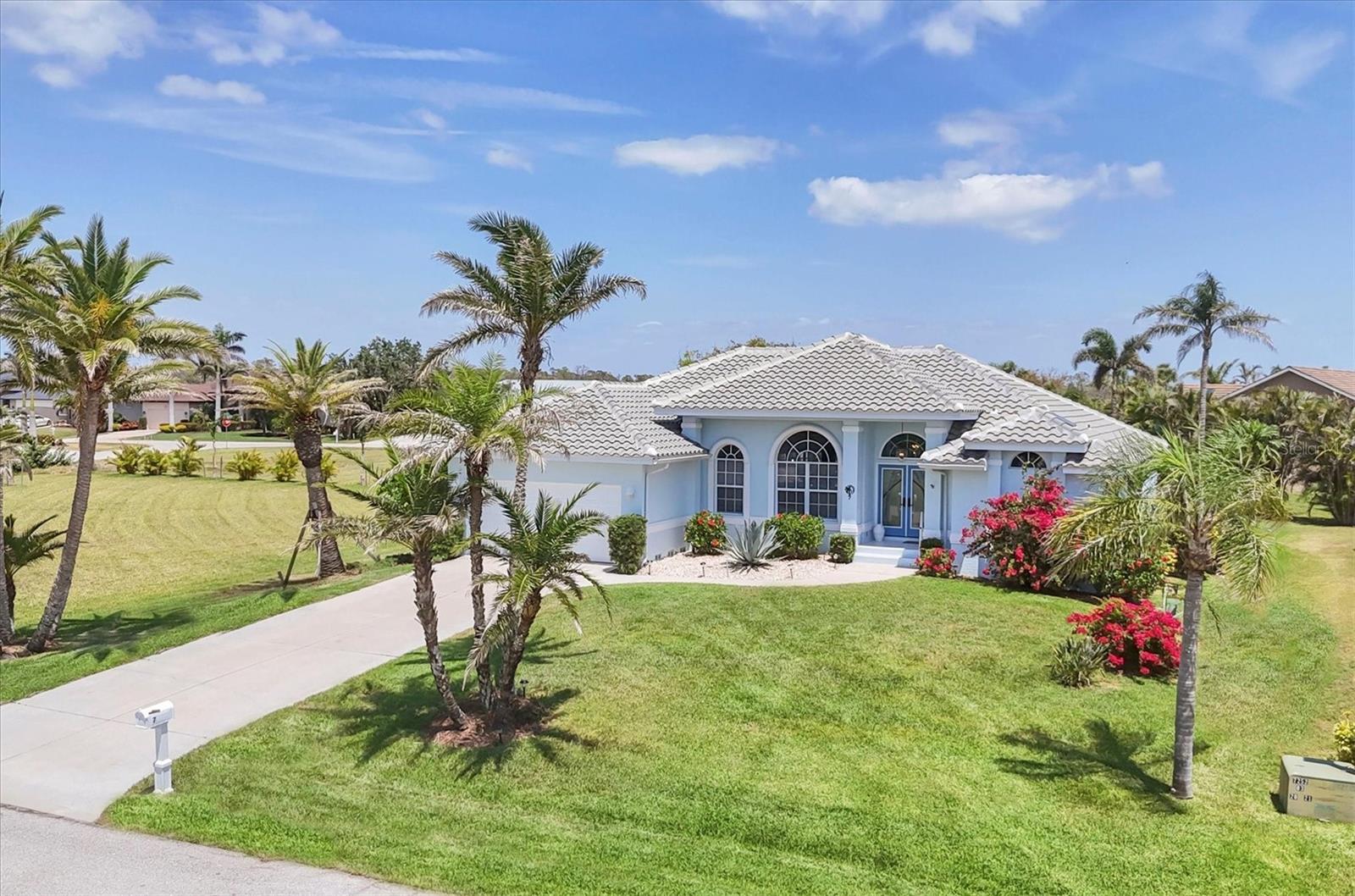 Welcome to your coastal retreat in the Cape Haze Windward community of Placida, where luxury, comfort, and peace of mind come together. Settled on an oversized lot of more than half an acre, this meticulously maintained property has been thoughtfully updated, completely move-in ready and hurricane protected. Brand new impact windows, an electric hurricane screen, and all-new lanai screens offer protection and tranquility year-round. The 2023 tile roof adds a fresh, coastal look and long-lasting durability. Large glass sliders leading to the lanai offer a seamless indoor-outdoor living experience with a sparkling pool view and mature landscaping for added privacy. The recently resurfaced pool comes with a lifetime warranty, and a new heater ensures year-round enjoyment. Inside, the home features a bright and open layout with soaring high ceilings and tile flooring throughout. The kitchen was fully remodeled in 2023 with all-new appliances including a dual oven, updated cabinets, quartz counters, and stunning backsplash. The kitchen is complete with a large breakfast bar, dinette area with additional cabinet and counter space, plus a formal dedicated dining room. The large master suite features two walk-in closets, pool access, a spacious bathroom with dual sinks, and a large soaking tub under the skylight with separate shower. A custom Murphy bed with built-ins, valued at $5k, adds flexibility and style to the second guestroom. The guest bathroom has been tastefully modernized featuring a tile shower with extended-height glass and a skylight for a spa-like touch. The dedicated laundry room with utility sink leads to the garage, which has been finished with epoxy flooring and a built-in workshop bench ideal for projects or extra storage. The property also boasts a freshly re sodded lawn supported by a well-fed irrigation system. Further updates include a 2020 electric water heater and a 2017 AC unit. Set in a quiet and desirable golf-friendly neighborhood close to Boca Grande beaches and boating, this home offers everything you need to enjoy the Southwest Florida lifestyle.