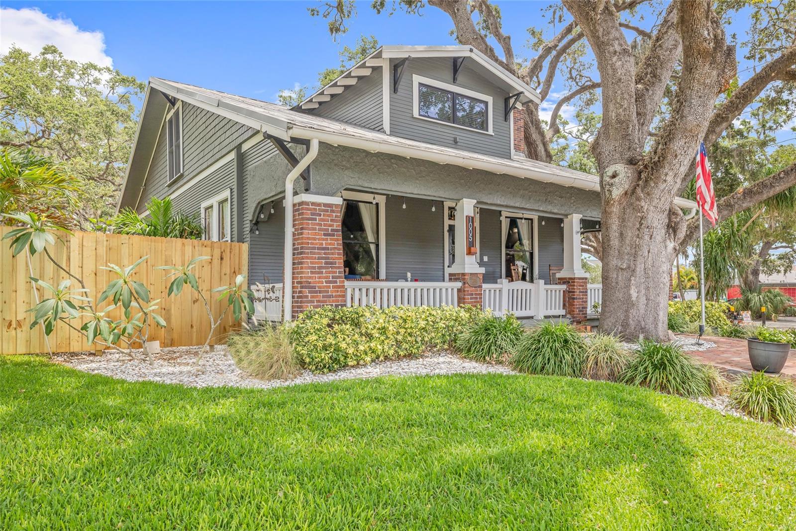 A true Safety Harbor original—full of warmth, charm, and history.
1005 Main Street isn’t just a home—it’s a front-row seat to one of Florida’s most beloved small towns. Built in 1915, two years before the town was officially founded, this 3-bedroom, 2-bath plus den Craftsman Bungalow sits proudly on a rare double lot right at the edge of downtown.
From the moment you step onto the string-lit front porch, the home feels like something out of a storybook. Inside, nearly 2,600 square feet unfold with refinished original hardwood floors, coffered ceilings, a cozy window bench, and built-in details throughout. The main level features a welcoming front sitting room, a large dining area, and a living room that flows seamlessly into the heart of the home—the kitchen.
The kitchen is warm, inviting, and full of character. Fully reimagined in 2020, it features quartz countertops, a marble backsplash, and a showpiece ILVE gas range framed by an arched brick wall built with reclaimed brick from Ybor City in Tampa. Just off the kitchen, the laundry and mudroom combo adds both function and charm, complete with a custom indoor dog wash station—perfect for post-park cleanups or muddy paws after a downtown stroll.
Downstairs also includes a guest bedroom and full bath, along with a flexible den or office space. Upstairs, the spacious primary suite includes an ensuite bath and walk-in closet, while the third bedroom brings in tons of natural light and charm.
Out back, the fully fenced yard offers a peaceful escape with artificial turf, mature trees, and a courtyard-style layout. Alley access, a circular driveway, and a detached shed offer added convenience. Approved for a pool, garage, or ADU, this rare double lot offers privacy when you want it and walkability to downtown when you don’t—the best of both worlds.
The home has been consistently cared for and thoughtfully updated. In 2020, the kitchen, family room, and laundry area were completely redone, along with new hardwood floors and custom finishes. Both bathrooms have been refreshed, and the upstairs bath received a full update in 2013. There are two central AC units—one just a few years old—the gas tankless water heater adds efficiency, and the standing seam metal roof had all its fittings replaced in 2020.
Plumbing has been upgraded with PVC, including a full sewer line replacement, and the electrical system includes two updated breaker panels. Spray foam insulation helps with year-round comfort, and foundation piers were redone in 2013.
A brand-new wood fence was added in 2025, the yard includes artificial turf, and the landscaping has been professionally maintained, with tree trimming in both 2023 and 2025. Other thoughtful touches include a 10x10 custom shed, full irrigation system, water softener, and string lighting that brings a cozy glow to the porch and backyard.
The home sits in Flood Zone X—no flood insurance required—and has never had storm damage. It’s high and dry, solid and sound, and ready for the next chapter.
And the best part? You’re just steps from everything downtown Safety Harbor has to offer. Walk or hop in the golf cart to Gigglewaters, The Brinehouse, HavenHouse Coffee, Water Oak, and the Sunday Market. With art festivals, live music, and local favorites all around, this home isn’t just a place to live—it’s a lifestyle.
This is more than just one of Safety Harbor’s original homes. It’s one of its most admired—and now it’s ready to be part of someone else’s story.