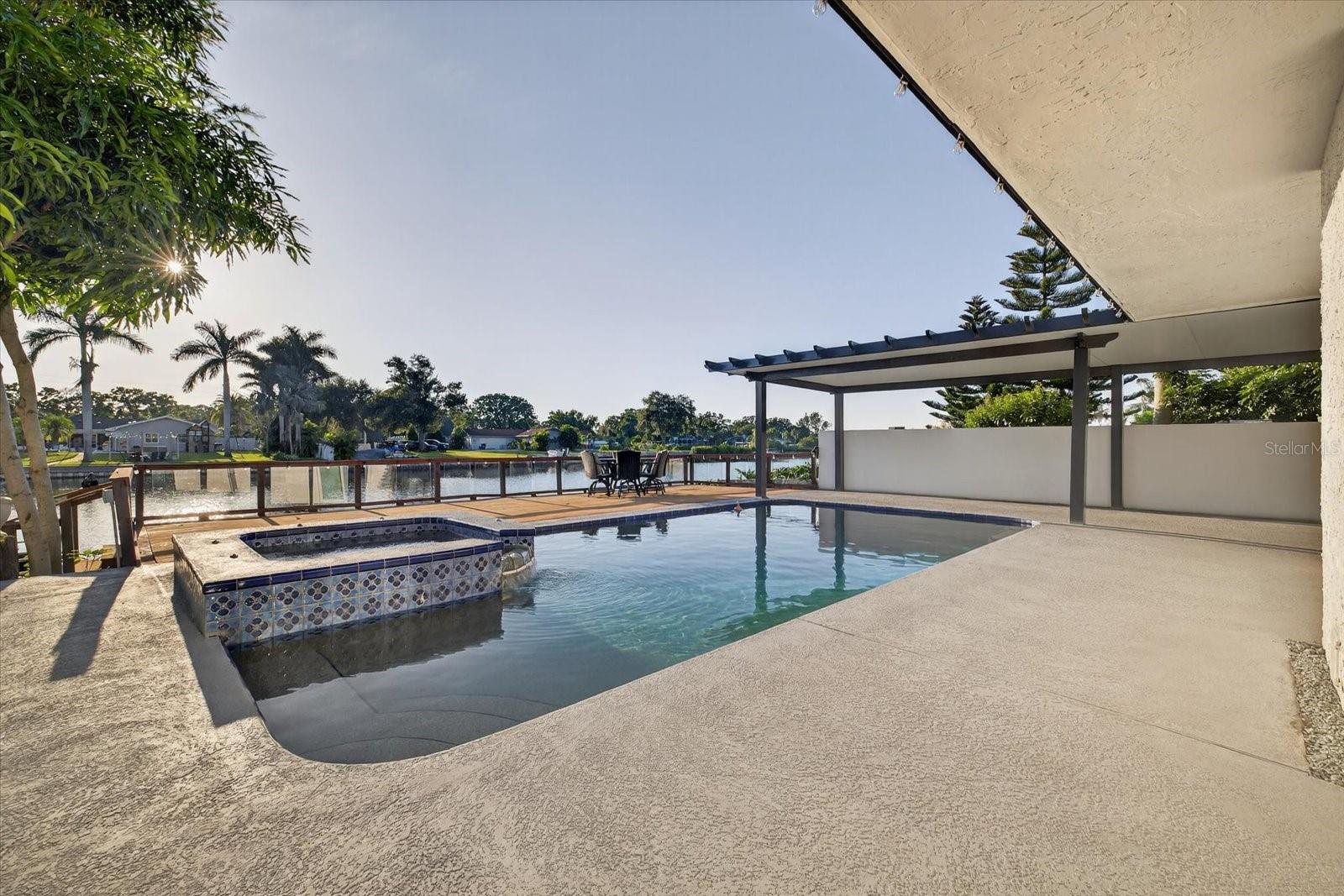 Experience Waterfront Paradise with Majestic Dolphin Visitors! Indulge in the exquisite charm of this opulent 5-bedroom, 3-bath, 3,152 sqft residence that will captivate your senses. Upon crossing the grand double doors and entering the foyer, you are instantly mesmerized by the elegance of the formal living room, transporting you to the vast family room adorned with a cozy fireplace overlooking the splendid waterfront pool and deck. Hosting lavish gatherings is effortless in the spacious dining room, while the delightful eat-in kitchen with breakfast bar and dry bar sets the stage for intimate family moments. Each bedroom is strategically placed for ultimate serenity, with the luxurious master suite boasting a rejuvenating jacuzzi tub, separate shower, and expansive walk-in closets. Unveiling a plethora of amenities, this remarkable abode is a must-see masterpiece that defies description. Don't delay, secure your appointment now and prepare to embark on a luxurious new chapter in your Florida lifestyle.