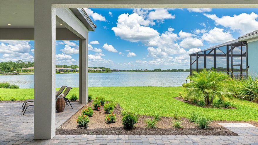 One or more photo(s) has been virtually staged. Welcome to the stunning 1504 Corfu Place, located in the exclusive community of The Alcove at Waterside in Sarasota County. This exquisite Portofino model with British West Indies elevation features an 8 foot 3-car garage extension and is perfectly situated on a premium upgraded lot valued at $254,000 at the time of purchase. This home has 4 large bedrooms, 4 full bathrooms, plus a Den/Office, second floor Bonus Room with a bedroom ensuite, first floor third bedroom with custom ensuite and a extended Lanai that has unobstructed panoramic views of Blue Heron Lake for those long sunrise mornings. Tucked away on a cul-de-sac street, this home has abundant privacy and includes numerous builder upgrades and owner custom enhancements. Notable structural upgrades include whole-house impact windows and doors, impact pocket sliders off the great room and primary bedroom suite, added foam insulation in exterior block, outdoor kitchen rough-in and venting, premium lot, prewire for a custom pool and gas heater stub out, 400 amp service upgrade for future solar/generator power, tankless gas water heater with recirculate system, extended primary bedroom suite with L-shaped lanai for privacy, smart home package, epoxy garage flooring, water loop for a future filtration system and ceiling fan prewiring in multiple rooms. It also features a second floor with bonus room, bedroom and bathroom. Inside, guests are welcomed by a foyer with two, 13-foot tray ceilings showcasing abundant natural light. The open-concept floor plan centers around a Gourmet Kitchen with an expansive quartz island, stainless steel appliances, a 36” hood and gas cooktop, wall oven/microwave combo, double-stacked cabinetry with crown molding, soft close drawers, and a hide-away, custom walk-in pantry with wood shelving and privacy door. The Great Room also boasts a 13-foot tray ceiling, recessed lighting and abundant natural light from pocket sliders with transom windows leading to the large double lanai space. Outside, pavers frame a generous covered lanai which is plumbed and wired for a future outdoor kitchen and future buyers custom pool. Adjacent to the great room is the dining room, which is wrapped in windows with a modern chandelier, offering a beautiful setting for both daily and formal entertaining. The split floor plan home provides privacy, placing the Primary Suite at the rear of the home. It features pocket sliders to the an upgraded L-Shaped Lanai for ultimate privacy from neighbors, two custom walk-in closets, and a luxurious ensuite bathroom with upgraded Bianco Covelano porcelain flooring, dual sinks, 56" high vanity mirror and vanity lights, walk-in shower, and custom vented wood shelving in the linen closet. Two guest bedrooms at the front of the home share a unique, custom walk-through closet area under the stairs. One guest bedroom has an ensuite bathroom with walk-in shower, while the other guest bedroom shares a hallway bathroom with walk-in shower, ideally positioned to serve both daily use and guests. The Alcove is an exclusive boutique community of just 47 homes offering a private and serene lifestyle while being minutes from Waterside Place and Waterside Park, farmers markets, wellness paths, volleyball courts, UTC, Downtown Sarasota, St. Armands Circle, and the Gulf Beaches of Siesta Key, Longboat Key, Lido Beach, and Anna Maria Island. Please view the Matterport Tour link to walk-through this home!