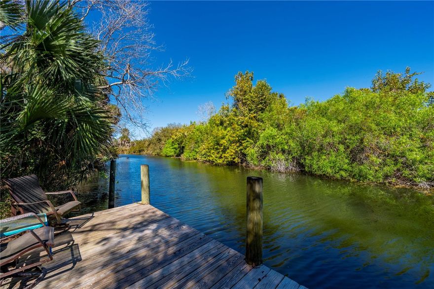 Welcome to your dream Waterfront Estate Home in Punta Gorda! This exceptional, 3.7-acre property features a Gated entrance, offering the perfect blend of luxury, privacy, and modern convenience. Owner Designed and Structural reinforced Concrete Built Estate Home, nestled in a private setting along Serene Alligator Creek, what a truly stunning Home. As you enter the front gates you will take in the beauty that the entire Estate is enveloped in carefully curated Florida-friendly landscaping, creating a true Florida paradise that follows through all the way to your dock on Alligator Creek. This Estate is very private and serene, but is wonderfully located close to shopping, dining, and quick access to I75 and Tamiami Trail. With just over 3,500 square feet of living space, this home is spacious and features a flexible floor plan to suit your needs and was designed for Income potential to function as an Airbnb along with offering Wedding and Memorial Venues, up to 35 times annually and 17 units of Real Estate Density.  This Beautiful Home Welcomes everyone from the Spacious Front Porch opening up to the Double Door entry, Crown Molding, Tray Ceilings, Transom Windows, Formal Living Space, Formal Dining Room, Executive Office, Family Room/Game Room, Large Kitchen with top of the line appliances, center Island abundant Solid Wood Cabinetry, Breakfast Bar, Granite Countertops,  Oversized Laundry Room with additional Storage, Split Floor Plan with Private Primary Suite with Split vanities, Jetted Soaking Tub, Separate Walk-in Shower, Large His and Her’s walk-in closets, 3 Guest Rooms, 3 Full Baths and an outside Half-Bath and separate heated outdoor Shower,  2 Screened Rear Patios giving way to More Living Space to take in the Quiet and Graceful setting. Car enthusiasts will appreciate the Detached 33x30ft AC Four-plus car garage with 3 overhead electric doors, providing ample space for vehicles and storage, along with an additional 30x15ft storage room with 2 overhead doors, a 30x15 covered patio/entertainment area, and a person Hot Springs Hot Tub.  Enjoy the Tennessee Flagstone walkways, an 80,000 galloon contained Natural Outside Lagoon/Pond with concrete bottom and walk-in Sandy Beach area, unwind in sounds of the Custom Rock Fountains, Waterfalls, plus a Koi Pond these Water features are accented throughout the backyard, perfect for enjoying the Florida sunshine offering a serene retreat for relaxation and rejuvenation. This Estate combines attention to detail, style, function, and flexibility in a Private, Expansive setting. The two adjacent 5 Acre parcels are available separately, giving you an opportunity to expand. Enjoy all the amenities that Punta Gorda has to offer, such as fishing, boating, Charlotte Harbor, golf, pickleball, tennis, bike and walk paths, dining, live entertainment, shopping and Historical Downtown Punta Gorda. Also take a Drive to award-winning beaches such as Boca Grande, Englewood Beach, Manasota Key just to name a few. We Invite you for Tour of this Exceptional Estate Home, let's make this yours!