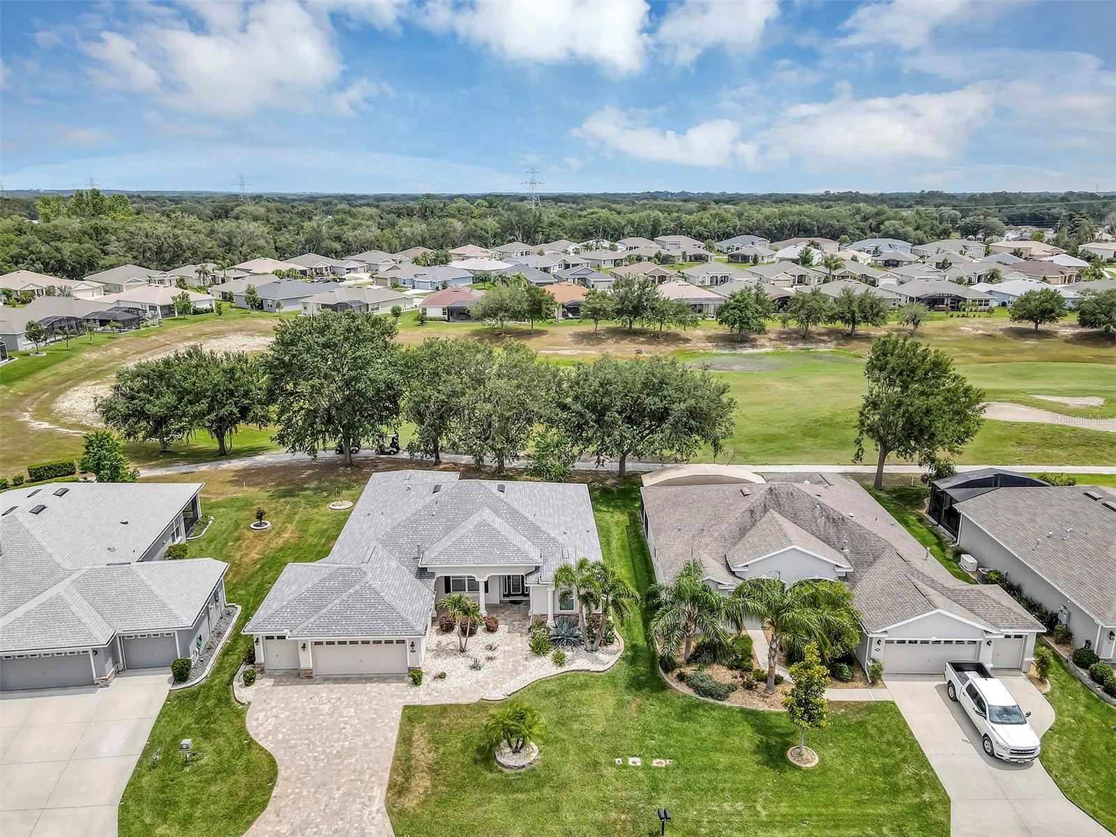ALOT OF HOME FOR THE MONEY! BOND PAID OFF, Affordable Golf-Front Living, 3 Bedroom 2 bath with 712 square foot 6 foot stretched 2 car garage plus golf cart garage with floored stairs to attic with floored area for extra storage, Huge 18x15 Family Room and living room both overlooking the golf course, A paver driveway, sidewalk & mature upgraded landscape package welcome you to this Custom Home built in 2019 Located in Highly sought after Arlington Ridge , A Guard Gated & Active Adult Golf Community. Discover a lifestyle of comfort and leisure you've waited for your whole life for, Very Low HOA of $125 per month includes, mowing, trimming & blowing of lawn Wi-Fi router for signal coverage throughout the home, 200+ cable TV channels, and 250-megabyte high-speed internet. Two DVRs are also included for recording your favorite shows which is all included, Low-maintenance stucco construction. situated on golf course, sidewalks and underground utilities for more luxurious feel . Living room boast open-concept floor plan and main areas rooms have crown molding, low-maintenance luxury vinyl and high ceilings enhancing the sense of space and inviting atmosphere. The modern design has rounded corners on sheetrock, Kitchen featuring abundant wood cabinets w/ pot drawers and pull-outs, granite counter-tops with long bar-top dining. The natural gas counter-top range and double door stainless fridge, wall-oven are included, a breakfast nook and separate dining room. The master bedroom features an en-suite bath with dual vanities w/ granite tops, a walk-in Roman shower, for added safety, private water closet, Extra Large walk-in closet . Split Plan for guest bedrooms provides ultimate privacy. ALL ROOMS HAVE 9 FOOT CEILINGS FOR EXTRA SENSE OF SPACE, Indoor laundry room with large extra pantry. 220+ s.f. covered & screened lanai with patio for grilling out and a golf view. home is located in low wind zone being in the center of the state. Benefit from huge discounts on homeowner's insurance due to the home's high construction standards being built to wind code, high & dry elevation for flood protection, and a low wind zone, also qualifying for additional insurance discounts. The low HOA of $125/month makes this community even more affordable than nearby communities This coveted community offers a wide range of amenities, including an 18-hole golf course where you can get a tee time year round, driving range, putting greens, YOU DO NOT HAVE TO PURCHASE A SOCIAL OR GOLF MEMBERSHIP TO LIVE IN COMMUNITY OR PLAY GOLF, lighted tennis and pickleball courts, heated swimming pools, hot tub, fitness facilities, billiards, a restaurant, tavern, and a free movie theater. The community is golf cart-friendly, with sidewalks for strolls and low-speed limit streets perfect for bicycling. Enjoy the convenience to grocery stores, restaurants, banks, and pharmacies within a 5-minute drive. Emergency services are just 10 minutes away, and a free boat ramp and fishing pier on a 15,000-acre lake are nearby. Community is 20 minutes from malls, restaurants, and a 12-screen movie theater, 45 minutes from Orlando, Major theme parks, and the airport, 90 minutes to Daytona Beach & Atlantic Ocean and Gulf of Mexico Clearwater. Home is not homesteaded, Living in home year round and homesteading will reduce property tax bill SJS 2025©