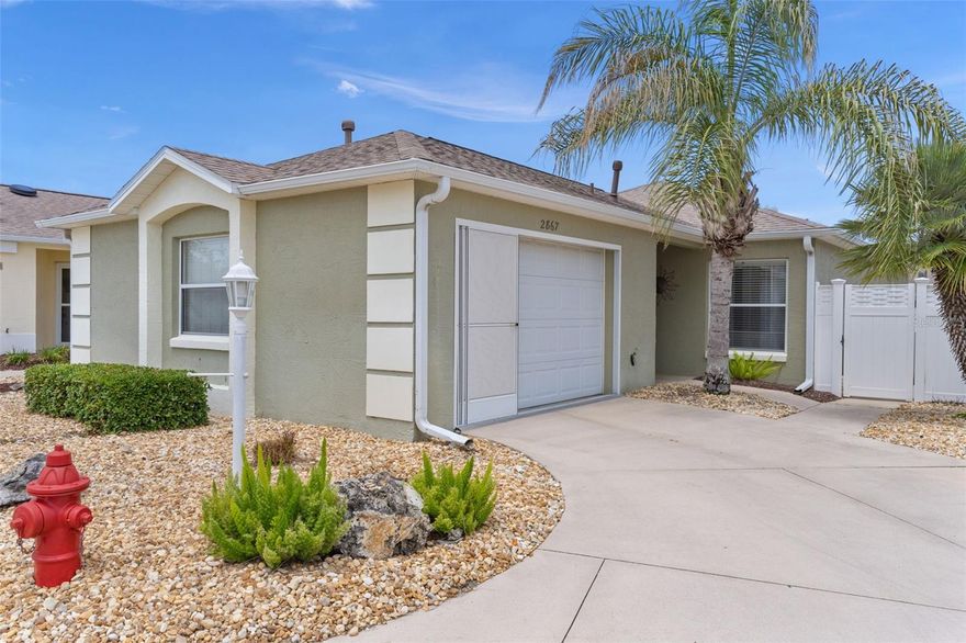 Turnkey block and stucco Courtyard Villa with gas golf cart in the heart of the Belmont Villas in the Village of Belvedere! This beautifully maintained Woodlawn model offers 2 bedrooms, 2 baths, and a 1.5-car garage—perfect for embracing The Villages golf cart lifestyle.
Step inside to a bright, open floor plan featuring granite countertops, tile backsplash, stainless steel appliances, gas cooking, natural wood cabinetry, and a pantry for added storage. The glass front door fills the home with natural light, while tile in wet areas and wood laminate flooring throughout (no carpet) provide both style and easy maintenance.
The private courtyard is a standout feature—complete with brick paver patio, multiple seating areas, retractable awning, gas grill, and low-maintenance landscaping with decorative rock. Enjoy Florida living year-round in the enclosed lanai with beautiful Chattahoochee River rock flooring—ideal for relaxing or entertaining.
Additional highlights include: Sleep Number bed in the primary suite, sleeper sofa, Ecobee smart thermostat with app control, and garage screen doors—all included for true move-in-ready convenience.
Major updates for peace of mind: Roof (2022), HVAC (2025), Water Heater (2023), Refrigerator (2025), Dishwasher (2024), TV (2024), and new irrigation control box.
Ideally located near Churchill Greens, Belmont, and Pimlico executive golf courses, plus the Belvedere pool. Just minutes by golf cart to shopping, dining, medical facilities, grocery stores, ice cream stops, rec centers with all their activities, and everyday conveniences including Costco, HomeGoods, Hobby Lobby, Bealls, Bonefish Grill, and Olive Garden—all accessible by golf cart.
Low bond: $2,362.89
Perfect as a primary residence, seasonal retreat, or investment property, this furnished courtyard villa offers privacy, low-maintenance living, and access to resort-style amenities. Don’t miss your opportunity to be in one of Florida’s most sought-after 55+ communities! Own a piece of paradise! Your Villages dream starts right here.