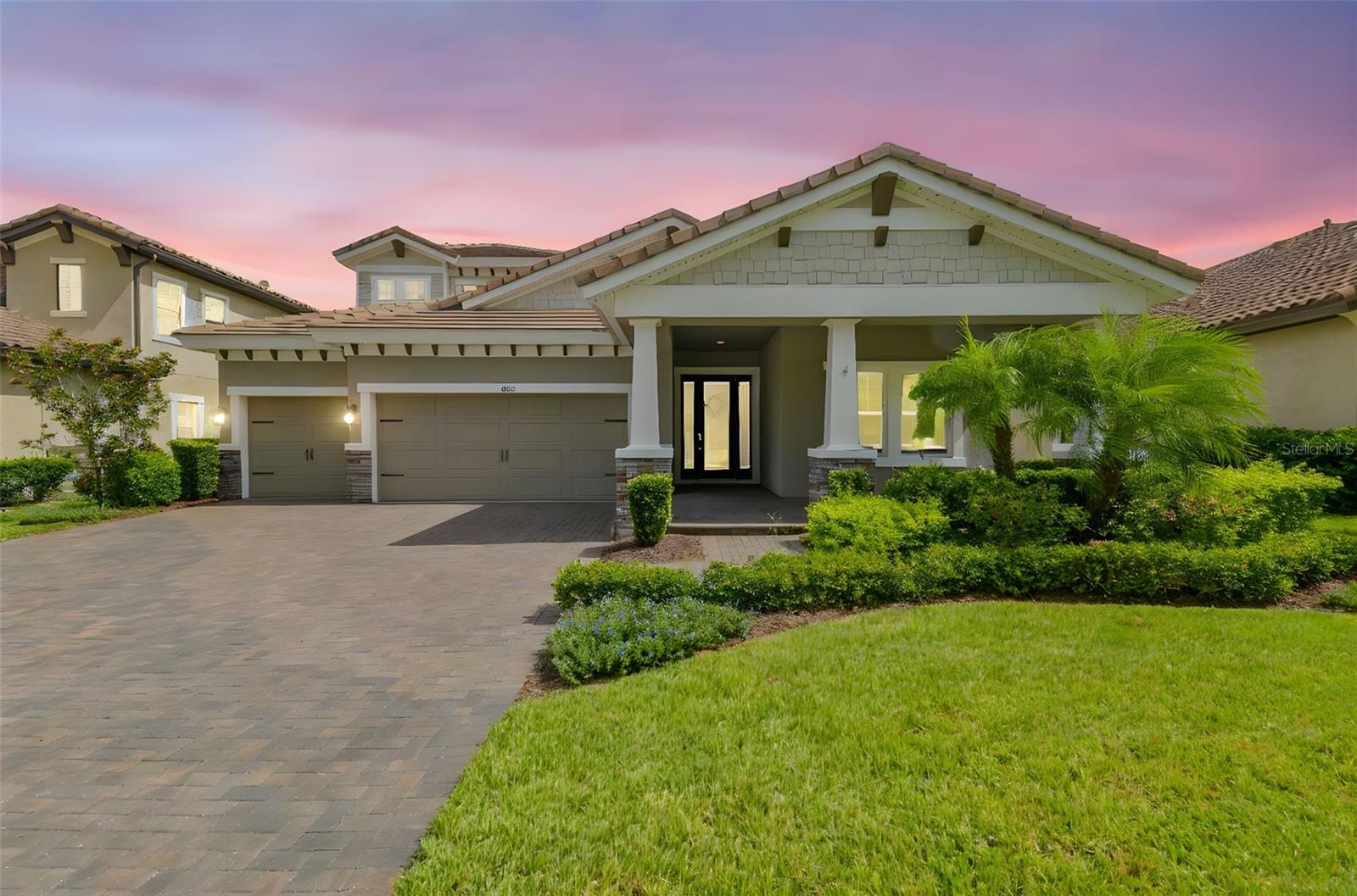 The ever-popular and exquisite Biscayne II floor plan by West Bay Homes has arrived. Located in one of Tampa Bay's most desired communities, Starkey Ranch, this 4 bedroom, 4 full bathroom, 3 car garage home with over 3100 sq ft of living space is sure to please. Stylish craftsman exterior with stone accents, exterior Nebula roof lighting, tiled roof, and meticulous landscaping draws you in. The front porch is a DREAM to have to sip your coffee and read a book with the stylish craftsman pillars. Open the door to the 11 ft tall ceiling in the foyer and high-end tile flooring. Thick crown moulding throughout along with 8ft doors. To your right, you have a bedroom conveniently located near a full bathroom with tiled shower and tub. Private and perfect for guests. You then have a bonus space that could easily be an office or playroom with stunning french glass doors. Continue through to the heart of the home and enjoy the lavish living room/kitchen space. Tray ceiling, beautiful private views through the sliding doors, tons of natural light, and a jaw dropping kitchen. The island has been extended and is covered in quartz. There are 42 inch tall espresso cabinets, endless counter space and storage, stainless steel appliances, large pantry, gas range with hood, modern lighting, and glass backsplash to make this home unique. The extension of the island was created as a gathering space for meals, homework, work, or simple conversation. Ample seating for entertaining. The living room also provides additional space for a dining room. The 100 in TV conveys! Floor outlet in place. Down the back hallway, you have the laundry room with sink that you enter from the garage, a full bathroom with an upgraded tiled shower/tub combo and another private bedroom. The beautiful architectural arches throughout the home adds a layer of elegance. Upstairs you find the perfect loft area for movie nights/second living room. Yet another private bedroom awaits you that has a full bathroom. Outside, the yard has been fully fenced with a 5 ft wrought iron fence, so you can still admire the views of the preserve and the water. The covered and screened in lanai is extended with gas hookup. Garage provides ceiling storage. Water softener with Reverse Osmosis is in place. Sealed driveway pavers. This home is located behind the gates in Anclote Reserve and across from green space. Starkey Ranch has become a highly desired community with its amenities such as: 3 community pools, a public library, the Starkey K8 school, the district park with baseball/soccer fields, playgrounds, dog parks, and miles of trails to bike, walk, or run on. There is an array of local wildlife to enjoy. Located near grocery, medical, restaurants, entertainment, shopping, and close to the Veterans Expressway for interstate/airport/downtown Tampa travel. Local beaches are 30 minutes away. This is your perfect location, community, and home. Please watch the walk through video for a virtual tour.