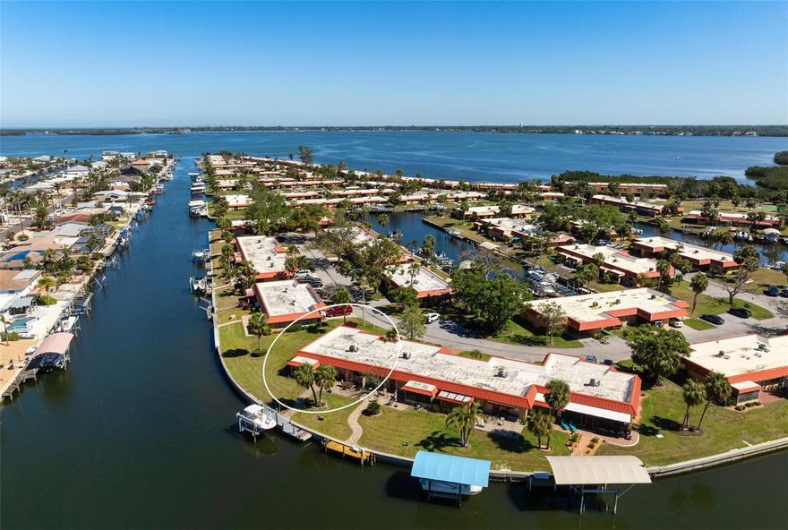 THREE BEDROOM, TWO BATHROOM CORNER CONDO in Palma Sola Harbour, a gated, waterfront community. Step out your back door to your own PRIVATE DOCK and 10,000 POUND BOAT LIFT, perfectly situated on the main canal. Enjoy the ultimate waterfront lifestyle with direct access to Palma Sola Bay and the Gulf of Mexico with no fixed bridges!!! The bright and open living area boasts spectacular water views, perfect for watching manatees play and breathtaking sunsets. A thoughtfully designed gourmet kitchen provides ample cabinet space, ideal for cooking and entertaining. Both guest bedrooms are spacious and filled with natural light, creating a welcoming retreat for family or visitors. Outdoor storage adds convenience, with plenty of space for bikes, tools, and all your boating and beach essentials. Palma Sola Harbour is a vibrant boating community with amenities that cater to an active and social lifestyle. Residents enjoy two heated swimming pools, tennis and pickleball courts, shuffleboard courts, and a charming park with a gazebo. The boardwalk over the bay waters is perfect for relaxing walks, while the putting green and practice area cater to golf enthusiasts. The clubhouse host various activities , billiards room, and 2 Swedish-style saunas. Additional amenities include a fitness center, workshop, and library, ensuring there’s something for everyone. Conveniently located with easy access to the Gulf of Mexico, this waterfront community is just minutes from beautiful beaches, shopping, dining, and the historic Cortez Fishing Village. This stunning condo offers a rare opportunity to own a piece of paradise with its private dock, boat lift, and unbeatable community features. Two pets are welcome, making it perfect for pet owners. Don’t miss your chance to live the waterfront lifestyle—schedule your showing today and make this exceptional property your new home!