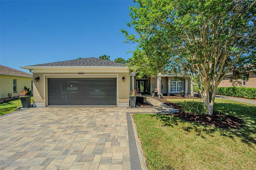 Wow! There are a total of 1,594 homes in the Tampa Bay Golf & Country Club community, and now one of the finest homes in here is available for you to own! This gorgeous 1,839 square foot home sits on a double-premium lot! Outstanding paver driveway/walkway and grilling pad out back. The garage has the very desired electric roll down screen .Watch the golfers putting out at the 15th green, while looking out your front door. Go around back to the HUGE lanai and look over beautiful retention ponds as golfers are teeing off at the picturesque 16th fairway. This home is beyond spectacular, and move in ready. Enter through the front leaded door with sidelights, New roof, 10/2024, new HVAC 6/2024, new water heater 2025. New interior paint, beautiful crown molding throughout the home. The lanai is amazing! 19'X20', vinyl windows, beautiful ceramic tiles, a ceiling fan and more. This home also has a full house attic fan! Tampa Bay Golf & Country Club is Tampa Bay's premier active 55+ community featuring two swimming pools (the large resort-style pool has fountains and is heated to a balmy 80 degrees). Pickleball, tennis, cards, bocce, shuffleboard, cornhole, and more activities than anyone could possibly do! Our new activities center has a HUGE fitness center with state-of-the-art fitness equipment, a beautiful billiards room, and an amazing card room. TBG&CC has no CDD and very affordable HOA charges, which include Cable/Internet/DVR and Mini Box. The Tampa Bay Golf & Country Club is Tampa Bay's most desirable 55+ Active community. All room sizes are approximate and should be confirmed by buyer(s). There is a ONE-TIME Social Membership Fee of $3,500.00 due at closing.