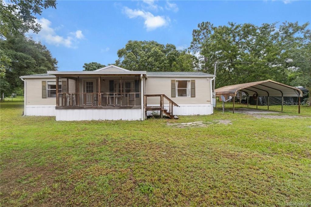 Nestled on a spacious half-acre corner lot in Homosassa's south Brent Point community, this 3-bedroom, 2 bathroom manufactured home offers a blend of comfort, functionality, and turnkey charm. Enclosed, re-screened porches at both front and back offering bug-free relaxation while the half-acre yard includes a large shed/workshop and covered carport-great for hobbies or parking multiple vehicles.