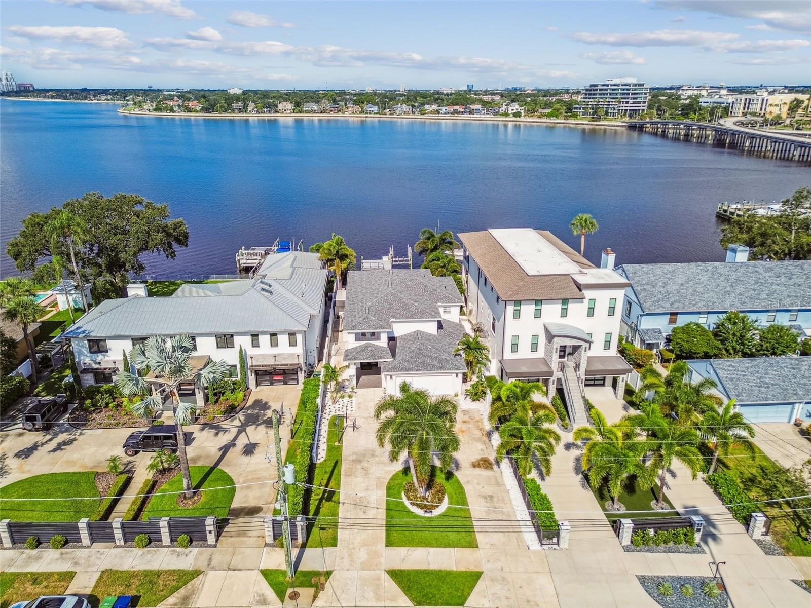 Very rare opportunity to lease a Davis Islands home, located on the OPEN BAY and just One Mile (by land or water) from the Water Street entertainment district! Bring your boat and golfcart! Now is your chance to experience this unique island lifestyle that is hard to beat. Small-town feel, yet minutes to downtown’s Riverwalk, Hyde Park Village, Bayshore Boulevard and Tampa International Airport. Davis Islands offers a village of restaurants, bars and shops, along with clay tennis courts, swimming pool, marina, yacht club, public boat ramps, small airport, two dog parks, Little League facilities, playground, parks/trails, a beach and Tampa General Hospital. No wonder golf carts are a favorite mode of transportation on the island! Contemporary waterfront home has been completely restored from the hurricane flood damage in 2024. A boaters' paradise, it sits on one of the most expensive streets on Davis Islands. When you enter, your eye will automatically be drawn to the glistening pool and open water of Hillsborough Bay beyond. Views abound from the roomy, open kitchen/family room space, which opens to the covered lanai. From the second-floor primary suite with a huge covered balcony and spiral stairs leading to the pool area below. Spoil yourself with these breathtaking water and sunset views (dolphins make appearances, as well). Backyard features a cabana bar, a beckoning pool, fire pit area, dock and boat lift (up to 10,000 pounds and a 27-foot boat). Inside are four bedrooms and four full baths among almost 3,400 square feet of heated space. The first-floor bedroom could make a perfect home office. The other three bedrooms and three baths are upstairs. Besides its picturesque views, the primary suite boasts a fabulous walk-in closet and a beautiful spacious bathroom. Top-notch schools: Plant High School, Wilson Middle School and Gorrie Elementary. Now is your chance — don’t wait to schedule your showing!