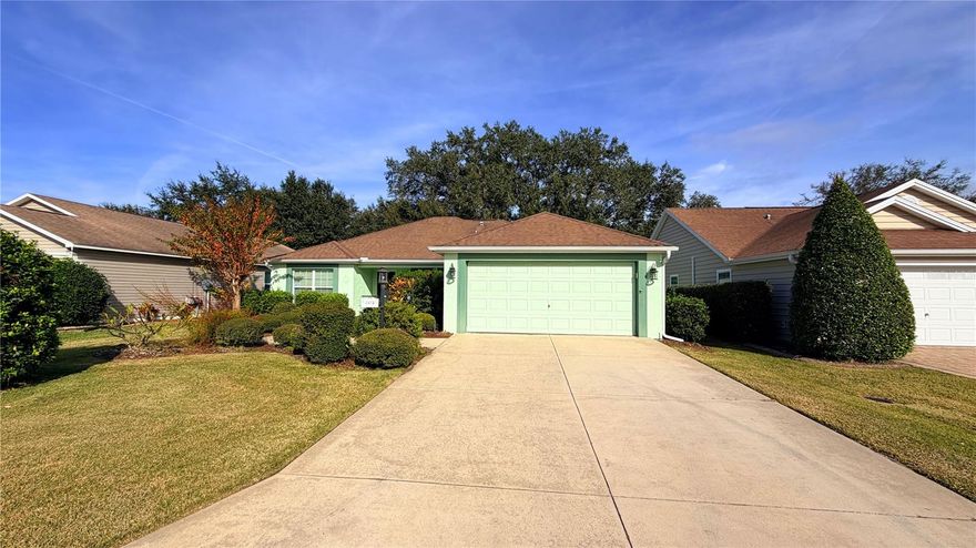 This beautiful block and stucco Alamanda home is located in The Village of Buttonwood. Located inbetween Sumter Landing Town Square and Brownwood. It is close to golf courses, shopping and dining. This is a 3/2 with a 2 car garage and a peaceful screened lanai looking out to nice landscaping for privacy. The flooring of this home is luxury vinyl throughout and tile in the wet areas, so no carpet! As you walk in, you will notice the vaulted ceilings to give it an open look as well as a solar tube in the Florida Room and laundry room. The kitchen has white appliances with a breakfast bar to enjoy your morning coffee. Microwave is new, refrigerator is 2020 and range is electric. (This is an all electric home). The primary suite has dual walk-in closets. The primary bath has dual sinks and a nice step in shower. A privacy slider separates the guest wing. Both guest bedrooms have closests and ceiling fans. One bedroom could be used as an office, if one prefers. Florida room is the perfect place to sit back, relax and watch tv. The laundry room is inside off of the garage, where you will notice a newer washer. The garage has pull down stairs for storage and a brand new water filtration system May 2025. Shelving in the garage stays with the home. Original Roof, HVAC 2024, Hot Water Heater 2022. Fire $320.71, Maint $595.31, Bond Payment $1,333.39. Bond Balance is $12,169.36.