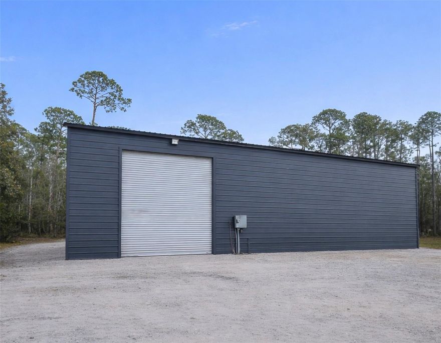 Under Construction. Discover the perfect blend of country living and future potential on this beautiful 5-acre parcel in highly desirable New Smyrna Beach. This property features a massive 50’ x 70’ metal building with impressive 16’ sidewalls and soaring 23’ peak height, designed with functionality and flexibility in mind. Equipped with pull-through 14’ roll-up doors, the structure is ideal for equipment storage, RVs, boats, workshops, or future expansion.

Inside, approximately 23’ x 50’ has already been professionally framed for a residential living space, offering a head start toward your custom barndominium vision. Permit inspections for rough-in and framing have already been completed, with the next steps ready for insulation and septic installation—saving valuable time and expense.

The property offers dual access from both Western Road and Canal Road, providing excellent accessibility and layout flexibility. Surrounded by the peaceful, rural charm of New Smyrna Beach, yet just minutes from shopping, and dining, this is a rare opportunity to complete a custom live-work property exactly to your specifications.

Whether you’re seeking a private homestead, workshop compound, or future residence with room to grow, this property delivers unmatched potential in one of Southeast Volusia County’s most sought-after rural communities.