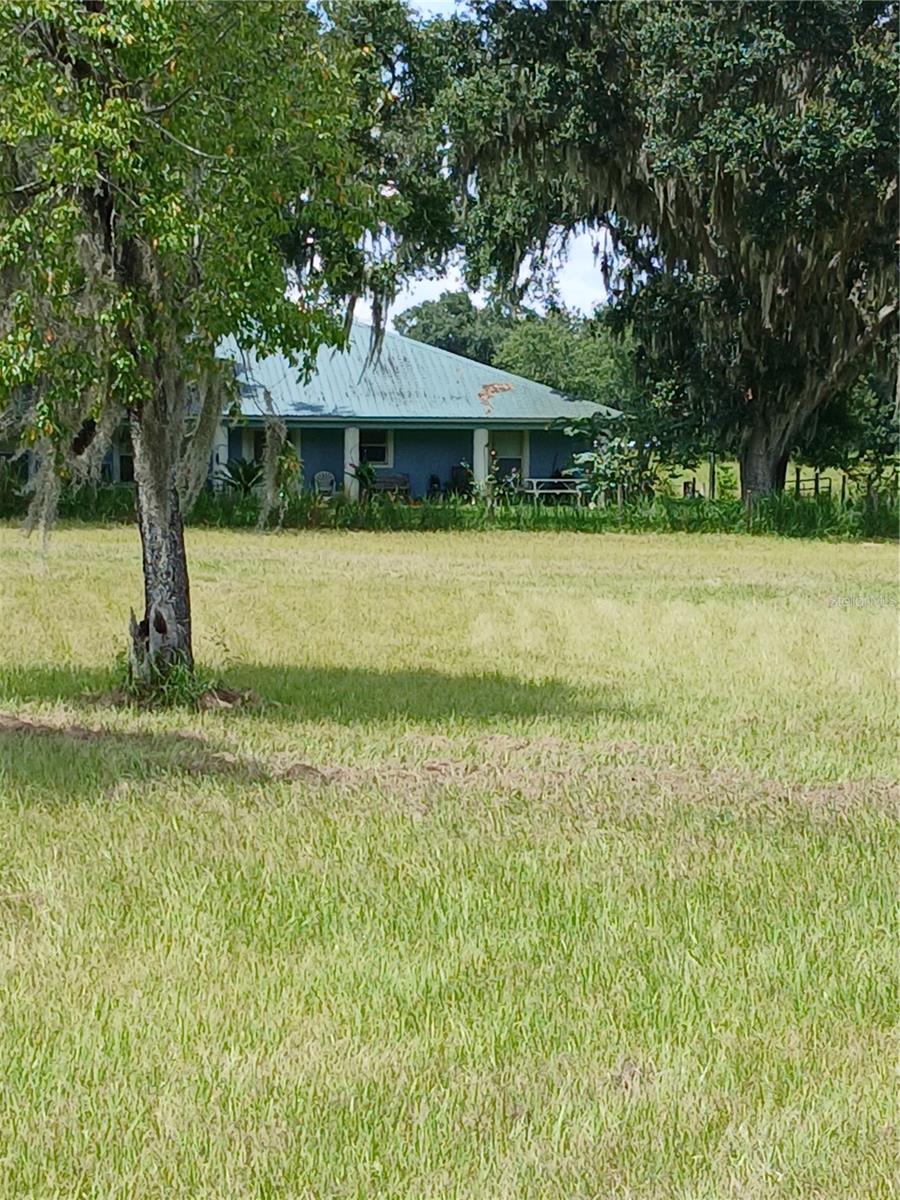 Almost 10 ac... Contemporary home, long front porch, screened in back porch. Huge detached 3 car grg, plus another free standing carport. Detached grg large enough for a shop also. Upon entry of hse, massive Great room; living room at front end, dining area at other end, family room on other side... Long, spacious kitchen. Master bedroom on one side, other 2 bedrooms and bath on other. Fenced in pasture.