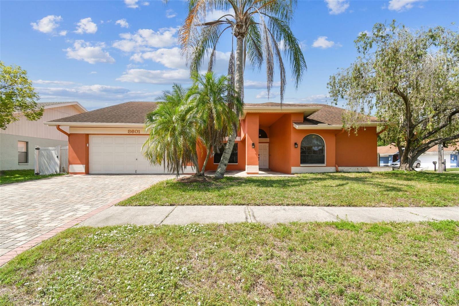 Welcome to this beautifully maintained home featuring an open-concept layout and screened saltwater pool, ideally located on a spacious corner lot in the highly desirable Countryway community. With 2,120 square feet of heated and cooled living space, this home offers a split-bedroom floor plan with 4 bedrooms and 3 full bathrooms. Enjoy soaring vaulted ceilings, neutral, calming tones, and tile flooring throughout the main living areas. The home includes formal living and dining rooms, a cozy family room with a fireplace, and ceiling fans throughout for added comfort. The gourmet kitchen is a chef’s delight with wood cabinetry, granite countertops, a breakfast bar, and stainless steel appliances. The spacious master suite features a vaulted ceiling, walk-in closet, dual granite vanity, garden tub, and a separate walk-in shower. Step outside to your private oasis—an enclosed, heated, saltwater pool perfect for year-round enjoyment. The covered patio area is ideal for al fresco dining, game day BBQs, or simply relaxing in the shade. Additional updates include a new roof (2018) and a whole-home water softener system (2020). Enjoy all the amenities Countryway has to show you, including golf, tennis courts, parks, and playgrounds. Conveniently located near shopping, dining, and the Veterans Expressway, with quick access to Tampa International Airport, downtown Tampa, and the Gulf beaches.