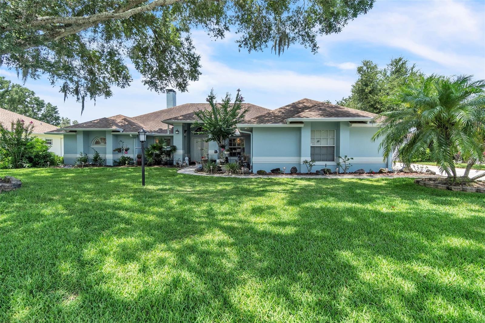 Welcome to this beautifully crafted 3-bedroom, 2-bathroom custom home, ideally situated on an oversized lot in the sought-after Hamilton Pointe community of Winter Haven. From the moment you arrive, the long, wide driveway and side-entry garage set the tone for the space and elegance that await inside. Step through the front door into a bright and open floor plan, perfect for modern living. The spacious living room features a cozy fireplace and large sliding glass doors that seamlessly extend your living space into the backyard—ideal for both relaxing and entertaining. The kitchen is a chef’s delight with ample light cabinetry, stainless steel appliances, a breakfast bar, and a charming kitchen nook. The open-concept design creates a natural flow between kitchen, dining, and living areas—perfect for gatherings. Retreat to the expansive owner’s suite, complete with private glass doors to the backyard, a spa-like bathroom featuring a garden tub, separate shower, dual vanities, and generous storage space. The additional bedrooms and guest bathroom are thoughtfully located on the opposite side of the home, offering privacy for family or guests. There is also a flex room that can be used as a home office, cozy den, or even a 4th bedroom to suit your needs. Outside, the oversized backyard is a true oasis, perfect for gardening and already home to a variety of imported tropical fruit trees that include mango, guanabana (soursop), guava and Rose Apple trees. A beautifully designed, functional shed enhances the property’s versatility, complemented by a finished 2-car garage with durable epoxy flooring and ample storage. This property with over 2.300 square feet of living space has more than $200,000 in renovations and enhancements with energy efficacy in mind and completed in the past couple of years such as whole-home generator, Hurricane-rated doors, New electrical panels, Wood flooring throughout, Custom PVC shutters, deep well, attic insulation, freshly painted inside and outside and so much more! Enjoy a prime location at Hamilton Pointe—just minutes from downtown Winter Haven and Highway 27, and only a short 15-minute drive to Legoland. Don't miss the opportunity to own this well-maintained, one-owner home near Lake Hamilton. Schedule your private showing today and make this exceptional property yours!