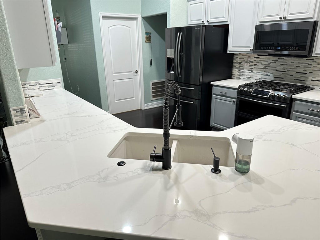 Photo of 1555 Blue Sky Boulevard, Haines City, FL 33844 (MLS # TB8544728)