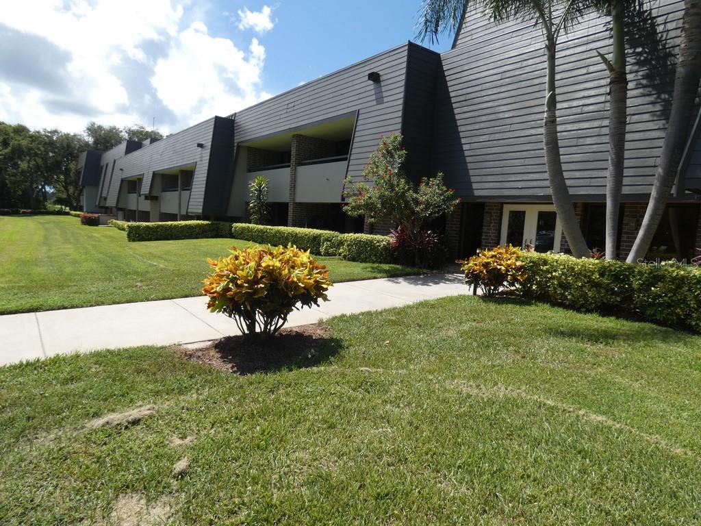 Nestled into the surrounding mature trees in The Innisbrook Golf and Tennis Resort you will enter this modern, moody loft condo that exudes all the urban charm with a dark, earthy edge. You will instantly view a spanning open-concept layout with all-encompassing natural light from floor to ceiling sliding doors. The matte black finishes against the warm tone flooring create an intimate, luxurious ambiance that will seat you directly on the comfortable, low- profile modern furnishings. A custom, modern dry bar set-up will seamlessly connect all your guests from kitchen to living areas and entertainment den. At the center of this loft condo is a custom gourmet kitchen designed for both form and function. The stained black cabinetry with two sprawling quartz islands and premium fixtures elevates the space for hosting intimate dinners of hand-crafted culinary delights to the most passionate of Foodies. It is a treasured haven for any aspiring French Baker as it is outfitted with GE Cafe Smart, Wi-Fi baking appliances. It becomes clear that storage is abundant throughout the kitchen spaces including a custom built floating buffet to house all the serving necessities.
Once you exit the living and kitchen area and step onto the framed balcony with your coffee or cocktail you will feel right at home above the sweeping views of a lush landscape and rolling hills of the golf course.
The Primary suite will not disappoint you with its size and moody charcoal walls combined with a distressed brick wall. For all the ladies who desire that spa-inspired bathroom, dressing room with large closets and dressers along with a beautiful soaking tub you have found your relaxation zone!
Discover your dream lifestyle at this all-inclusive resort today! Enjoy world-class golf, swimming pools, clay tennis and pickleball courts and a Spa massage with sauna to wind down. Reserve a lunch date overlooking the greens of Copperhead Course or make time for a tasty dinner of ribeye steak at Packard’s Steakhouse.
For a closer look, please be sure to view the two property tours available: Tour 1 and Tour 2.