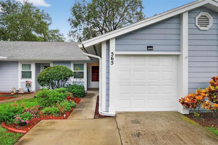 One or more photo(s) has been virtually staged. Welcome to this well-maintained 2-bedroom, 2-bathroom villa in Tarpon Springs! Situated across the street from A.L. Anderson Park on beautiful Lake Tarpon, and not far from Honeymoon Island State Park, this cozy villa offers a rare blend of nature, privacy, and convenience.

Step inside to find a spacious open-concept layout featuring tile and wood-style flooring, vaulted ceilings, and the perfect amount of light. The timeless kitchen boasts crisp white cabinetry with Corian counters, a full appliance package, and a pass-through window to the dining area, making entertaining easy and efficient. The adjoining living and dining space is perfect for gatherings or relaxing evenings, with sliding glass doors that lead out to a screened-in patio, perfect for enjoying the beautifully maintained garden.

You'll also love the private garage, ideal for parking or extra storage, and appreciate the low monthly COA fees that cover exterior maintenance, water, sewer, trash, cable, AND internet. Whether you're downsizing, buying your first home, or looking for a seasonal retreat, this property is sure to check all the boxes!