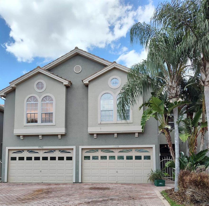 WATER VIEWS! Great PALM HARBOR location! All from this spacious canal waterfront 3 bedroom, 4  bath townhome with a 2 car garage! Located minutes from grocery store, shopping and eateries! Large living room has a fireplace as well as a lovely water view of the canal. Sliding door lead out to a screened enclosed patio for your enjoyment any time of the day! Features large Kitchen, separate dining area for your holiday gatherings. Upstairs is the large master bedroom with a fireplace, walk in closet and en-suite bathroom. Master bedroom has sliding doors that open onto a screened in balcony with a beautiful water view. The other 2 bedrooms are good sized rooms! Tarpon canal allows for small water crafts to enjoy the Florida sun! Heading out to Lake Tarpon, a large freshwater lake known for fishing and fun in the sunshine!