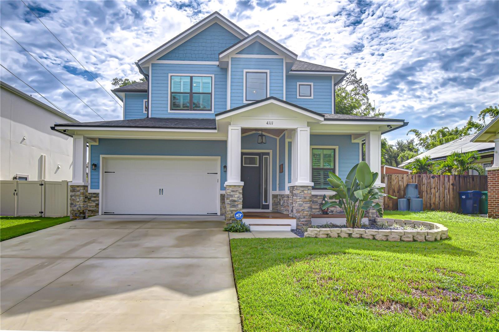 Get ready to fall in love with this exceptional Custom Home in the Heart of South Seminole Heights. Tucked away in one of Tampa’s most sought-after neighborhoods, this tastefully appointed and lovingly maintained 4-bedroom, 3.5-bathroom home—built by Titan Builders—is a true showstopper! From the moment you arrive, the stacked stone accents, charming architectural details, and a welcoming front porch create undeniable curb appeal and set the stage for everything this home has to offer. Step inside to a bright, airy floor plan highlighted by luxury wide-plank flooring and plantation shutters that flow seamlessly throughout the entire home. At the heart of the home, the gourmet chef’s kitchen looks straight out of a design magazine with 42” soft-close cabinetry, stylish glass-front cabinets topped with crown molding, a spacious walk-in pantry, gas range, and a convenient butler’s pantry for added storage and prep space. Top-of-the-line stainless appliances include a gas range and built-in oven, while an oversized center island with bar seating and upgraded countertops make the space both functional and beautiful. The open layout blends the kitchen, dining, and great room into one inviting space, perfect for entertaining or casual nights at home. A custom accent wall, beautiful sliders, and abundant natural light set the stage for modern elegance. At the front of the home, a dedicated office/flex room provides the perfect spot for working from home, study, or creative pursuits. A stylish downstairs laundry room features chic tile flooring, added storage, and plenty of function to keep daily life organized. The first-floor primary suite is a retreat of its own with plantation shutters, a spa-inspired en-suite featuring coastal design touches, a walk-in shower, and a massive walk-in closet with custom organization. Upstairs, a spacious loft provides flexible living—ideal as a game room, media lounge, or home gym. Two additional bedrooms share a stylish full bath with marble shower, while a private en-suite bedroom makes the perfect guest quarters. Step outside to discover your huge fenced backyard, ready to be transformed into your dream outdoor oasis—whether that’s a pool, summer kitchen, or lush garden sanctuary. A covered back porch offers the perfect setting to enjoy a quiet evening or create lasting memories while entertaining with family and friends. And here’s the best part: enjoy all of this with no HOA and no CDD fees while being minutes from Hyde Park, International Plaza, Tampa International Airport, top-rated restaurants, and Amalie Arena. This is the rare blend of modern luxury, location, and lifestyle you’ve been waiting for in South Seminole Heights. Copy and paste this link to tour the home virtaully with this link: my.matterport.com/show/?m=PPhsbFN84yY&mls=1