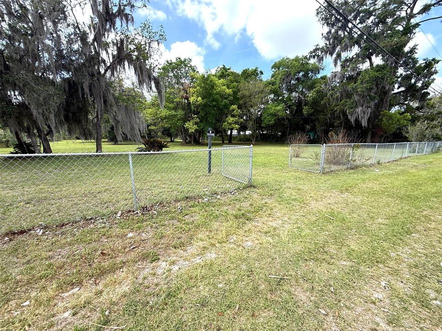 PERFECT ACREAGE HOMESITE. Build your own sanctuary within the city on this spacious 1.37 acre lot, conveniently located just over a mile from downtown Ocala in a quiet and established neighborhood. It is a short drive or even walking distance to Tuscawilla Park which features a beautiful lake with paved walkway surrounding it, sports complex and playground; where the Reilly Arts Center, a state-of-the-art performing arts center and the Discovery Center, a hands-on children’s science center are located. It is a couple of blocks to the Southeastern Livestock Pavillion which hosts events like rodeo, derbies, festivals and other events. The lot is dotted with trees like majestic oaks and a stately magnolia tree providing natural shade, fresh air and greenery. On one side is a row of growing fruit bearing Japanese plums or loquats and an orange tree.  This spacious lot with 195 ft. street frontage and a depth of 306 ft. offers you ample space for your RV, boat, greenhouse, storage building and an inground swimming pool. You can use your imagination and creativity to turn this piece of land to a slice of paradise of your own. The lot provides enough room to build an auxiliary dwelling unit (ADU) for a guest house, in-law apartment or rental unit for extra income. You also have the option to subdivide the lot into two parcels for two separate homes. Clear ready to build lot, fully fenced. Power connection onsite. Public water and sewer. Paved roads. No HOA.