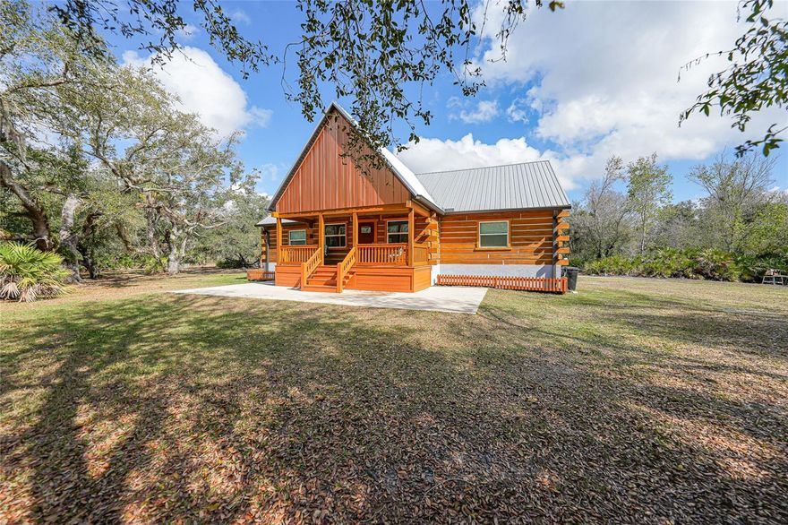 Log cabin in Florida? Yes… and it’s every bit as cool as it sounds. Tucked away on nearly six peaceful acres, this custom-built log cabin feels like a mountain getaway somehow dropped right into the Florida countryside. You get the quiet, the privacy, the wildlife, the pond, the pool… and you’re still just minutes from town. It’s the best of both worlds. The moment you pull up, the covered front porch sets the tone. This is the kind of place where mornings start with coffee outside and evenings end with nothing but the sounds of nature around you. Inside, the home opens up with soaring cathedral ceilings and a bright, airy living space that feels both cozy and grand at the same time. The open floor plan flows easily from the living area into the kitchen and dining space, making it perfect for everyday living or hosting friends and family. The kitchen features stainless steel appliances, tons of prep space, and easy access to the dining area where double French doors lead straight out to the screened lanai. The layout includes three bedrooms and two bathrooms, with a spacious primary suite that has its own private bathroom. The two guest bedrooms share a convenient Jack-and-Jill bath, making it a great setup for family or guests. There’s also a finished loft that adds extra flexible space… perfect for a home office, reading nook, or additional storage. Step outside and the fun really begins. The expansive screened lanai surrounds a heated pool with a newer salt cell generator, creating the perfect spot to relax, entertain, or cool off on those warm Florida days. Just beyond the pool you’ll find a stocked pond (tilapia) with its own dock, ideal for fishing, watching wildlife, or simply soaking in the peaceful views. Two storage sheds give you plenty of room for tools, toys, or hobbies. And the upgrades? This home is loaded with them. A whole-house reverse osmosis system, grinder pump septic system, newer well pressure tank, hurricane impact windows, and a durable metal roof all add to the quality and longevity of the property. And one thing worth mentioning… this is not a kit cabin. This is a true custom-built log home that was thoughtfully designed and built to stand out. If you’ve been dreaming of a private retreat where you can slow down, spread out, and enjoy the beauty of nature without sacrificing modern comforts… this might be the one. Welcome to your Florida log cabin escape.