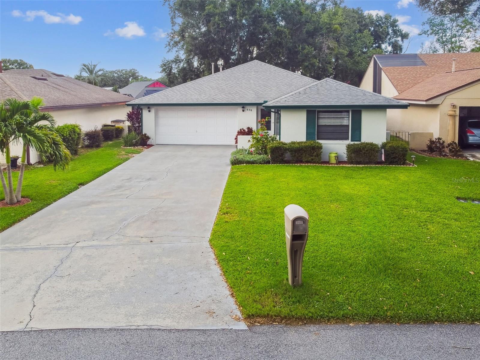 Welcome to 676 Augusta, a charming and well-maintained home nestled on a beautifully landscaped 0.18-acre lot with majestic oak trees and a serene backyard setting. The tiled entry foyer leads into a spacious living and dining area with updated carpeting, which opens seamlessly to an enclosed Florida room—perfect for relaxing or entertaining. The kitchen features stainless steel appliances, a custom closet pantry, and tiled flooring for easy maintenance. The primary bedroom offers direct access to the Florida room and includes a stylish bowl sink in the en-suite bathroom, along with a generous custom walk-in closet. Throughout the home, you'll find ample storage, including a partially floored attic for added convenience. Recent updates include a new water heater and furnace in 2025, and a roof replacement in 2016. The attached two-car garage is equipped with washer/dryer hookups and extensive built-in storage. It feels expansive and private thanks to the mature oak trees and thoughtful landscaping. This home combines comfort, functionality, and charm in a peaceful setting—ready for its next owner to enjoy. Situated in Cypresswood Golf & Country Club, a guard gated community with; 18 Hole championship golf course with clubhouse, restaurant, pool and tennis courts. Easy access to hwy 27 and I-4.