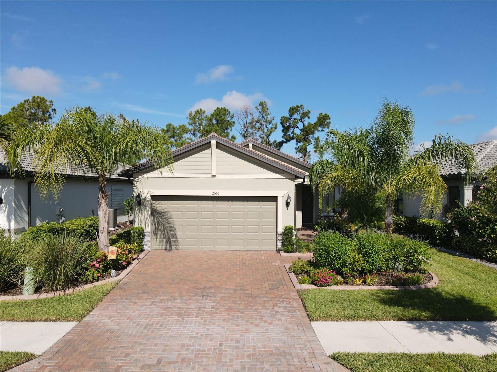 **3D VIRTUAL TOUR** Enjoy resort style living in the 55+ active adult, maintenance free, gated, Del Webb community of Cypress Falls! NOT IN A FLOOD ZONE, EVACUATION ZONE "E"! This home is a rare TAFT Model, feauturing a cozy and inviting interior feel, this meticulously maintained 2 bedroom, 2 bathroom home is an extraordinary find! Pull into your driveway and be greeted with lush Florida landscaping including curbing, palm trees, lush green grass, exterior lights, stone enhacements and the scent of flowers in bloom as you make your way into the place you'll call "home." Open the front door and be welcomed to an inviting foyer entrance and admire the neutral paint colors, 9ft high volume ceilings, and freshly steamed tile floors throughout the main living area, making cleaning a breeze and pet friendly! The open layout connects living spaces seamlessly, while the well-appointed kitchen with a huge kitchen island makes meal prep and baking a breeze. The kitchen is a chef's delight, featuring stainless steel appliances, granite countertops, closet pantry, plant shelves, ornate tile backsplash, an abundance of solid wood cabinets aligned with crown molding, and the soft close feature with pull out shelves for the ultimate in organization, including a corner lazy susan cabinet and trash compartment. The SILGRANIT kitchen sink is a luxury item you won't find anywhere else! Complimented by a central island, highlighted with pendant lights, this space offers additional seating and dining options and extra storage space. The dining room is showcased by a modern hanging light, and overlooks all of your main living areas so you won't miss out on any of the conversations when entertaining family and friends. Double French doors lead you into a quaint den/office space that would also make an excellent game room, playroom or craftoom - the possibilities are endless! The stunning primary bedroom and bathroom are a haven of tranquility, featuring dual sinks, walk-in-shower and granite countertops. A large walk-in-closet with ample shelving provides plenty of storage space for your entire wardrobe. The guest bedroom and bathroom are secluded down the hallway, with privacy in mind for your out of town visitors. The guest bedroom is equipped with a private closet, window and ceiling fan, and the guest bath has a vanity with large mirror, light fixture, and shower/tub combo. A charming SUNROOM off of the kitchen is the picture perfect spot to relax with a good book or catch up with an old friend. The OVERSIZED GARAGE has an additional 4 ft extension, and the floor has an epoxy finish! Step outside to the screened in lanai and watch the beautiful sunsets every evening while dining outdoors and enjoying the gorgeous weather Florida has to offer. Lots of natural wildlife in your own backyard with Heron & Crane visiting regularly. The vibrant community features a clubhouse, tennis courts, dog park, community center, and entry access pools & spa which is just the beginning! Enjoy pickleball courts, bocce ball, billard's, ping pong, horseshoes, library and internet cafe. Are you the social type? Come take part in the numberous clubs and classes, crafting, bridge, poker, yoga, tai chi, water aerobics, dance and more! Community events like Bingo and parties which add to the vibrant lifestyle. With numerous beaches and golf courses nearby, Cypress Falls presents the lifestyle you've longed for, where every day feels like a vacation.