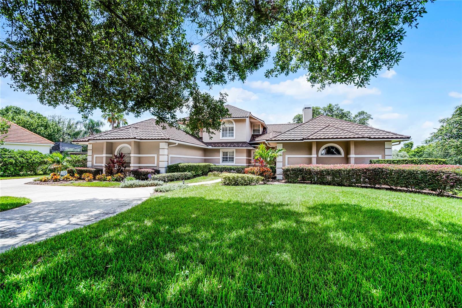 A SPECTACULAR South Bay home! Conveniently located near the Sand Lake Road and Apopka-Vineland Road intersection, and sitting on an oversized pie-shaped cul-de-sac lot, is one of the nicest, custom homes in the area. A 2-story, classic Florida custom home that has nearly everything a family would want. High ceilings, crown moldings, engineered wood floors throughout, natural light, soothing modern decor and quality materials and craftsmanship. The Primary bedroom and bath couldn’t be better - great size, Plantation shutters, 2-way fireplace, built-ins, huge dual vanity with granite counters, an oversized Garden tub & dual-head walk-in shower, spacious organized walk-in closet with drawers & wood floors. HUGE Family Room-Kitchen combo features an elevated breakfast bar island, Granite tops, Travertine backsplash, 42’ custom cabinets, stainless appliances, walk-in pantry, wet bar with ice maker & wine cooler, an abundance of drawers, fireplace with stacked stone & mantle. Also on the main level is the 5th bedroom with a deep closet, or as a home Office. An oversized laundry room leads to a home gym with laminate floors, mirrored wall and circulated air (this was a 3rd car bay, and is easily converted back!) The second floor is comprised of 3 bedrooms, Jack n Jill full bath, and an En Suite, all beautifully appointed, great for guests or kids. An ENORMOUS 52’ covered Lanai features classic Mexican tile, wood ceilings, a full walk-up Entertainment bar & multiple sets of French doors. Inviting screened pool & spa(recently resurfaced), surrounded with a brick paver deck. LARGE, fully fenced yard, custom shed & Greenbelt views. Rounding out this amazing home is a NEW Stone-coated Metal roof with gutters, large side garage, circular driveway and beautiful landscaping with 2 mature oaks located away from the home, but with nice front shade. South Bay community features include a playground, tennis/pickleball, jogging trails and a fishing dock. Arnold Palmer’s Bay Hill Club & Lodge is a short golf cart ride. Dr. Phillips restaurants, shopping and 3 Publix are within minutes. A really delightful, comprehensive property.