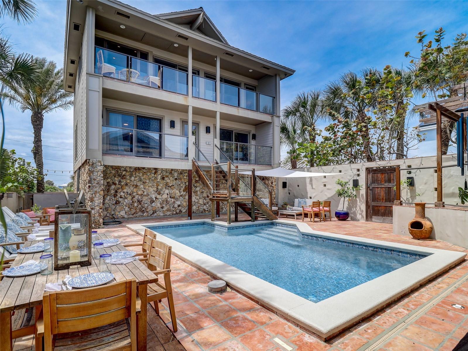 Over 10% Below Market Value – Motivated Seller Has Already Purchased Replacement Property!
Oceanfront Luxury in North Beach – Where Flip Flops Meet Sophistication
Discover the pinnacle of coastal living in this exquisitely renovated 4-bedroom, 4-bathroom oceanfront estate, nestled in the prestigious North Beach area of Central Florida. Perfectly balancing relaxed elegance with high-end design, this residence offers private beachfront access and uninterrupted views of the Atlantic Ocean.
Step into a world of comfort and style where surfers riding waves become your daily backdrop, viewed from the expansive oceanfront deck and master suite.
Highlights include:
Dual Living Areas – Ideal for multi-generational families, private residence + guest house, or corporate retreats.
Oceanfront Master Suite – A true sanctuary featuring a cozy sitting area, fireplace, and a 9' x 26' en-suite/dressing room.
Chef's Kitchen – Outfitted with custom bamboo cabinetry and premium appliances by Sub-Zero, Bosch, Wolf, and Fisher & Paykel, plus a 6' x 8' walk-in pantry.
Family Room – Warm and inviting with built-in window seats, a fireplace, and direct access to a 19' x 19' cedar deck.
Private Walled Courtyard – Lush tropical landscaping surrounds a sparkling swimming pool, offering the ultimate in seclusion and serenity.
Guest House – Includes a second master suite, dedicated office with custom built-ins, and two additional bedrooms—each with full bathrooms and walk-in closets.
Luxury Flooring Throughout – A stylish mix of polished concrete, bamboo wood, and travertine tile for durability and elegance.
3-Car Garage – Complete with built-in storage and a secondary laundry area for added convenience.
This rare oceanfront gem is priced more than 10% below market value, presenting an unmatched opportunity in today’s luxury market. The seller is highly motivated and ready to move, having already secured a downsized property.
Live the essence of “Pura Vida”—pure life, pure luxury, pure Florida beachfront. This is more than a home; it’s a lifestyle.