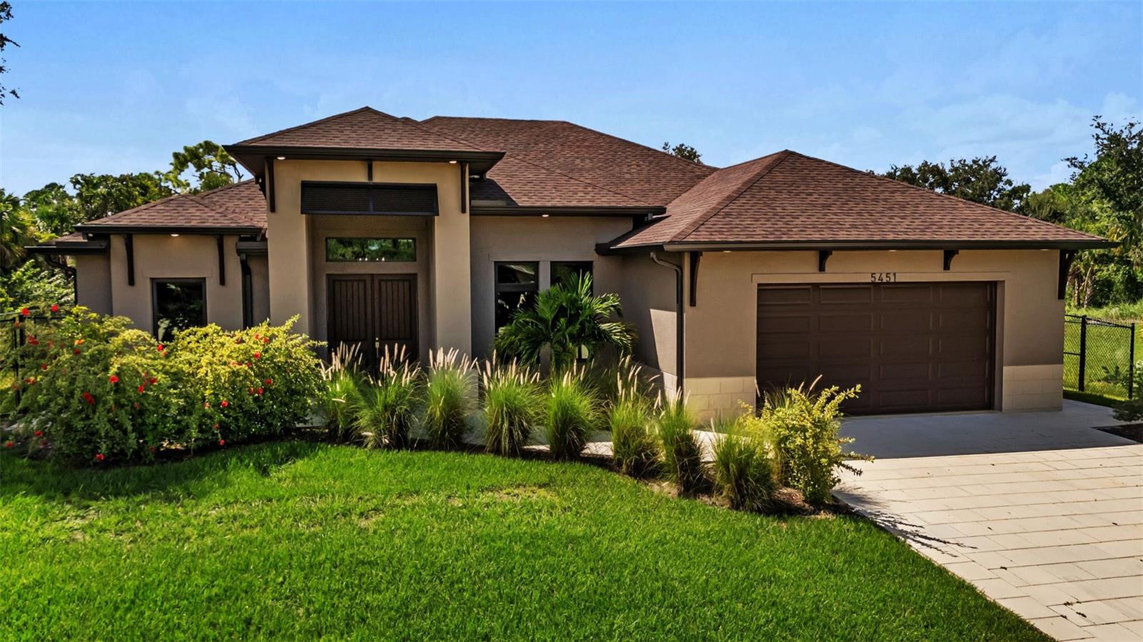 Step into this beautifully crafted 4-bedroom, 2-bathroom home offering over 2,000 square feet of thoughtfully designed living space. Completed in 2023, this modern residence blends high-end finishes with functional elegance, featuring soaring ceilings, luxury plank flooring, and an abundance of natural light that flows throughout the open-concept layout.
At the heart of the home is a stunning gourmet kitchen, designed to impress and built to perform. Granite countertops, stainless steel appliances, a large center island with seating, and tall, custom cabinetry provide both beauty and functionality—ideal for everyday living or hosting guests. Adjacent to the kitchen, the spacious dining and living areas create a seamless environment for family gatherings and entertaining.
The split-bedroom floor plan ensures privacy and comfort, with the expansive primary suite offering a peaceful retreat. It includes a large walk-in closet and a spa-inspired en-suite bathroom with dual vanities, elegant finishes, and a walk-in tiled shower. The three additional bedrooms are generously sized and versatile—perfect for family, guests, or a home office.
Enjoy the best of Florida living in the covered lanai that opens to a private, oversized backyard. With plenty of room for a pool, garden, or play area, the outdoor space invites endless possibilities. The home is positioned on a spacious lot with mature landscaping, paved streets, and no rear neighbors—offering privacy and tranquility.
Additional features include hurricane impact-resistant windows and doors for year-round peace of mind, a 2-car garage with epoxy flooring, a spacious laundry room, and energy-efficient systems throughout. Located in a quiet, residential area of North Port with no HOA or CDD fees, the home provides easy access to local parks, top-rated schools, dining, shopping, and major highways. Nearby attractions include CoolToday Park—spring training home of the Atlanta Braves—and the popular Warm Mineral Springs.
Why wait for new construction when this move-in ready home delivers modern design, quality construction, and space to grow—all available now?
