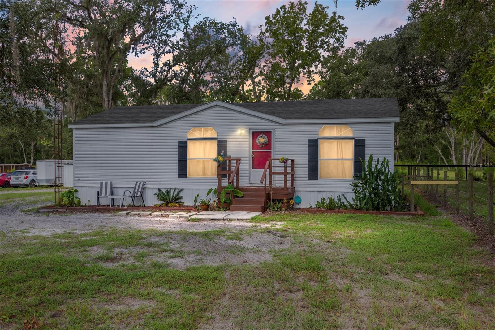 Discover equestrian living, a charming 2-bedroom, 2-bath home with an open floor plan, updated kitchen, and inviting front porch. This property is move-in ready and perfectly set up for horse enthusiasts with a fenced paddock shaded by beautiful oaks and a solid block garage conversation with offering stalls, tack space, and equipment storage. With plenty of room for trailers and easy access to Ocala, the Rainbow River, and the World Equestrian Center, this property blends comfort, convenience, and the equestrian lifestyle at an unbeatable value.