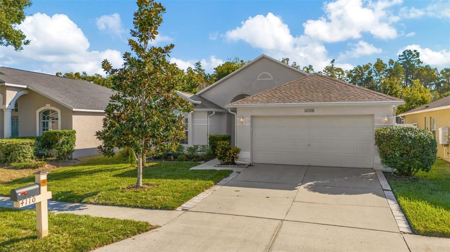 Your new home welcomes you. This beautifully updated classic ranch style home is located in the coveted gated Oakstead community. This charming home features three bedrooms, two bathrooms, open large living area and an enclosed porch. Recent upgrades include new wood shaker kitchen cabinets and new LVP flooring installed throughout the main living areas and all bedrooms. Kitchen features stainless steel appliances with breakfast bar. Inside laundry closet with included washer and dryer is conveniently located adjacent to the kitchen. New roof installed in 2025. The master bedroom features two walk-in closets; the master bathroom has a double vanity, tub and shower. Storage shelves in garage. Living in Oakstead provides access to an exclusive, gated community lifestyle. The amenities include clubhouse, resort style pool, splash pad, playground, fitness center, tennis and basketball courts. Low HOA fees. This prime location in Land O'Lakes is highly desirable, with exceptional schools, Elementary, Middle, and High School at a close distance.  Community is conveniently located near shopping, dining, entertainment, and major highways allowing easy access to Tampa, Wesley Chapel, and surrounding areas. Don't miss out on this wonderful opportunity!