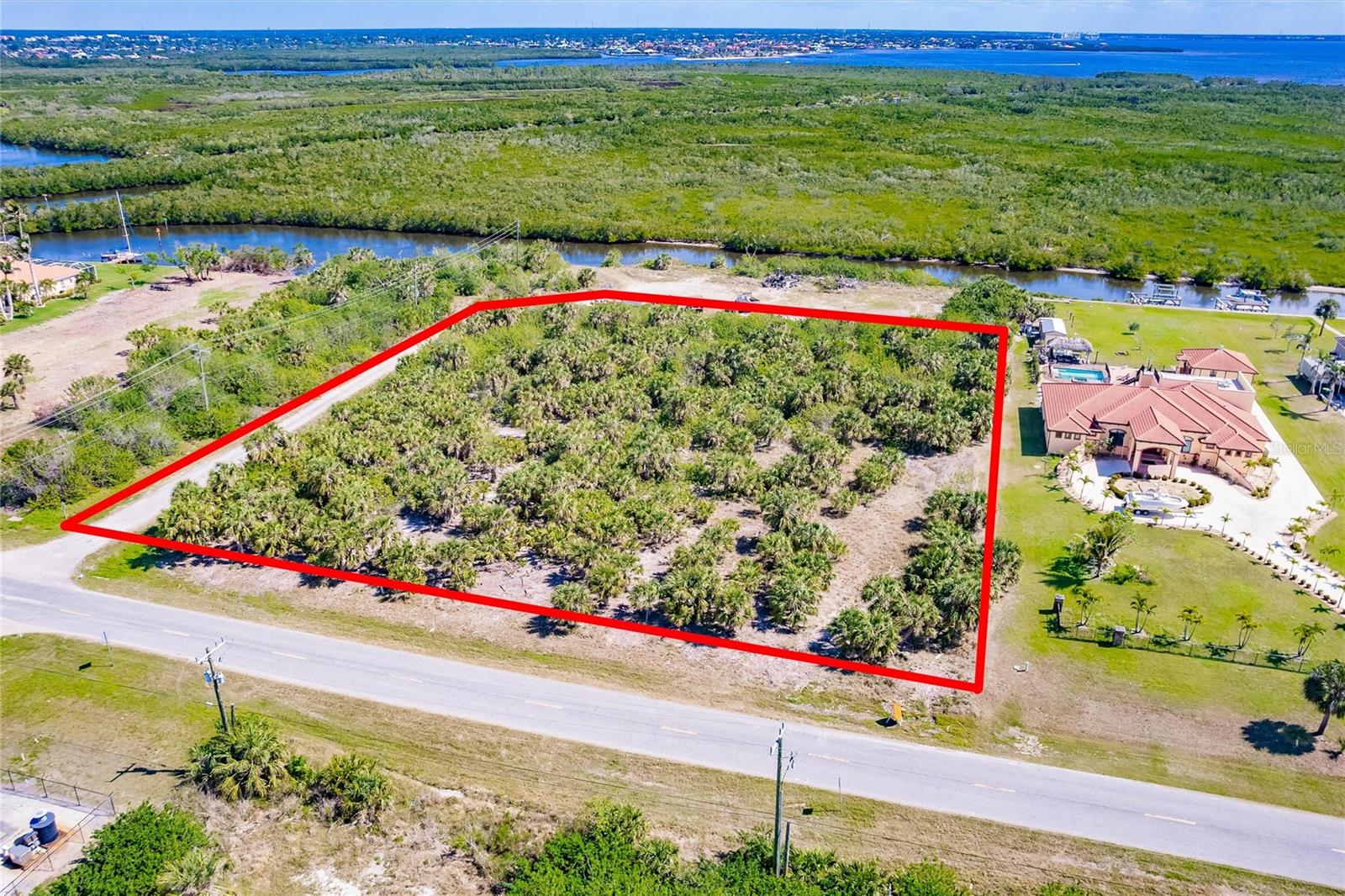 Discover an exceptional opportunity with this commercially zoned vacant lot at 19155 Midway Boulevard, Port Charlotte, FL. Perfectly positioned in a high-traffic area, this property boasts a fantastic location with direct views of the scenic Manchester Waterway Canal. Whether you’re looking to develop apartments, condos, or another commercial venture, this lot offers unmatched potential in a growing community.
With convenient access to U.S Route 41 and I-75, local businesses, and residential neighborhoods, this property is a rare find for investors and entrepreneurs alike. Don’t miss your chance to turn this prime piece of land into a thriving business!