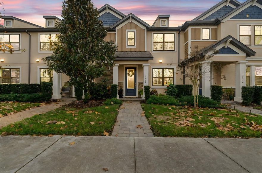 Imagine living in one of the most popular communities in Tampa Bay. This MI Home townhome with a "Pottery barn" feel, is offering 3 large bedrooms, 2.5 bathrooms, and an attached 2 car garage. Located across the street from Cunningham Lake and the preserve, the views are spectacular and the miles of walking/hiking/biking trails are easily accessible. With a freshly painted exterior in 11/2025, this modern  luxurious home has been professionally landscaped. Walk up the paver walk-way to the covered front stoop and come inside to experience high ceilings, an open floor plan, a stunningly bright kitchen with quartz countertops, 42 inch cabinets, stainless steel appliances, 5 burner gas range, refrigerator, and earth toned vinyl flooring throughout the main level as well as the stairs. Relaxing living room space with an electric fireplace/mantel and a designated area for your dining table. Modern upgraded light fixtures. Additional seating at the kitchen counter top. Several picturesque windows with shutters provide natural light and privacy. The laundry room is located on the main floor tucked away with extra storage, utility sink and a 1/2 bath. Drop zone/storage/bar area beautifully built and decorated for your use. Beautiful staircase to the upstairs takes you to separate 2 bedrooms that are spacious, and the private owners retreat with ensuite. Dual sinks, quartz counter tops, large walk-in tiled shower and glass enclosure. Closet space will not disappoint. Second full bath is a shower/tub combo. Take your living space to the outdoor oasis that is private and screened in. You can enjoy grilling, entertaining, relaxing, or playing here. You can keep the house open year round. Patio is attached to the 2 car garage. Reverse Osmosis/water softener in place. On street parking is in front of the home for guests to easily access. Located near one of three community pools. A few blocks from the Starkey K8 school and the county district fields. There is so much adventure awaiting and activities to do in the community and Starkey Ranch has their own Lifestyle team that plans yearly events for the residents. This townhome has a low HOA that includes exterior maintenance, lawn care/fertilization, sewer and trash so you have little to do. Located near the local Publix, restaurants, medical, entertainment, and easy access to the Veterans Expressway for travel to Tampa. The warmth and opulence of this home is undeniable. This is a must see. Click on video for virtual walk through.