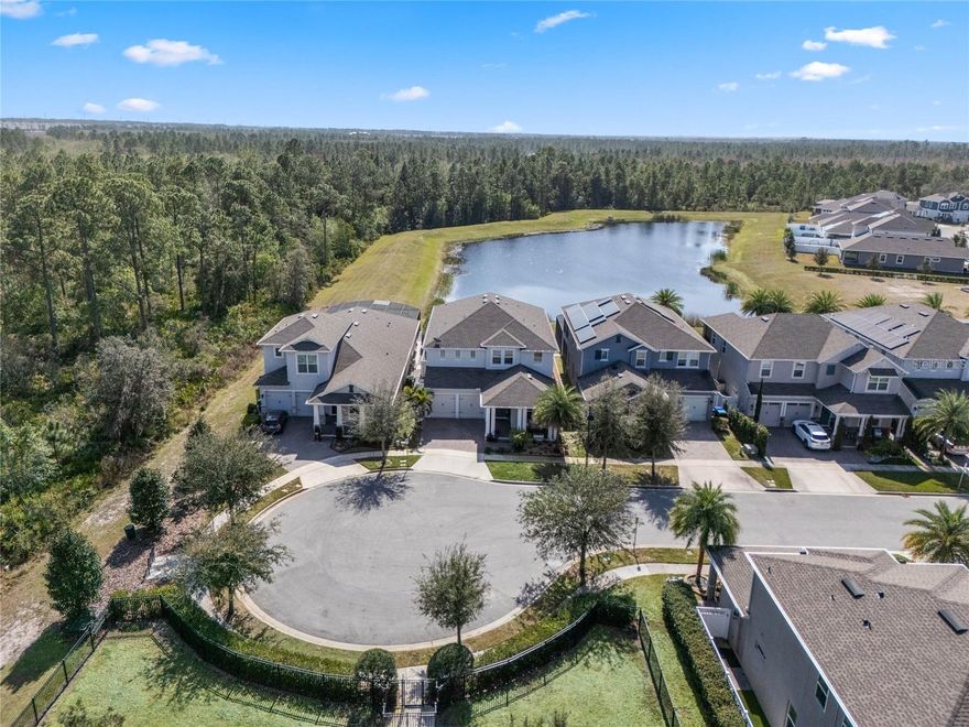 Set within one of Winter Garden’s most loved communities, this thoughtfully designed two-story home offers a lifestyle shaped by ease, connection, and everyday enjoyment in Winter Garden, Florida. Morning walks along sidewalks, friendly neighbors, nearby parks, and resort-style amenities create a rhythm that feels relaxed yet vibrant. With top-rated schools, convenient access to shopping and dining, and Walt Disney World Resort just minutes away, the location blends Central Florida convenience with the feeling of being tucked into something special.

From the moment you step inside, the home invites you to slow down and take it all in. Natural light fills the space, drawing your eye through the open living area to peaceful pond views and the private pool. Beyond the pond, a wooded area owned by Disney provides a protected natural backdrop that will never be built on, preserving privacy and tranquility. Oversized white tile spans the first floor, creating an open, airy atmosphere that feels clean and welcoming.

At the center of the home, the kitchen is designed for real life and real gatherings. White cabinetry, granite countertops, a double oven, and a statement range hood anchor a space that works effortlessly for weeknight dinners or hosting friends. A large walk-in pantry keeps everything organized and within reach. Just beyond, the family room feels warm and grounded, with a stone accent wall, electric fireplace, and custom shelving creating a comfortable place to relax.

The first floor offers flexibility to suit your lifestyle. A dedicated den or home office provides a quiet place to focus, while a formal dining room invites shared meals and conversation. A drop zone near the garage keeps daily routines running smoothly. Toward the back of the home, a spacious downstairs bedroom with a full en suite bath offers privacy, ideal for guests or multi-generational living.

Upstairs, an open loft serves as a central gathering space for movie nights or game days, enhanced by a stone wall and theater-style seating. The owner’s suite feels like a true retreat with a tray ceiling, spa-inspired bath featuring a rain shower, dual sinks, generous storage, and two oversized walk-in closets. A private balcony overlooks the pond and wooded preserve, offering a peaceful place to enjoy morning coffee or unwind.

Three additional upstairs bedrooms provide ample space for family or guests. Two share a hall bath, while one enjoys its own en suite for added comfort and privacy.

Outside, the backyard feels like a private Central Florida escape. A resort-style saltwater pool with a lounging platform and in-water loungers overlooks the serene pond, creating an inviting setting for relaxing afternoons or entertaining. The screened enclosure allows for year-round enjoyment, and the community dog park directly across the street adds everyday convenience for pet lovers.

With fresh interior paint and plantation shutters throughout, this move-in ready single-family home is ready for its next chapter. Community amenities include a resort-style pool, oversized cabana, sports fields, playground, sidewalks, and a dog park. This is more than a house — it is a place to settle in, build memories, and truly feel at home in Winter Garden.