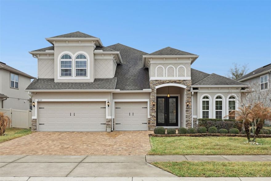 This stunning five-bedroom, four-bathroom, three-car residence is situated in one of Central Florida’s most desirable and rapidly expanding areas. This thoughtfully designed home boasts an exceptional floor plan featuring the primary suite and three additional bedrooms on the main level, complemented by a private second master suite and a dedicated media room upstairs. The media room is equipped with a projector screen, surround sound, and a bar with a mini-fridge.The home welcomes you with glass inset double front doors, high tray ceilings, elegant light fixtures, and statement ceiling fans throughout. The living room features a custom-built stone-accent fireplace with an electric fireplace and built-in shelving.The gourmet kitchen is equipped with upgraded appliances, a natural gas cooktop, a double oven, and a large island with ample seating—ideal for both everyday living and entertaining.Triple-stacking glass sliders open to a screened-in patio and fully fenced backyard. There is a natural gas connection on the lanai for your grill. The three-car garage offers ample storage and epoxy floors.Additional features include a whole house water filtration system, mudroom located near the garage, under-stair storage, eight security cameras with closed-circuit TV capability, a Ring doorbell, two Nest thermostats, and keyless entry.This beautifully upgraded home offers space, functionality, and modern convenience in a prime location. 

Ardmore Reserve offers resort-style amenities including a community pool, sun deck, veranda, and shaded playground—and no CDD fees. Conveniently located near the Florida Turnpike, the community provides easy access to Disney and area attractions (approx. 30 minutes), Orlando International Airport (approx. 40 minutes), downtown Clermont and Winter Garden, shopping, dining, golf courses, trails, the National Training Center, and major retailers such as Costco, Publix, Target, and Home Depot. The new AdventHealth Minneola Hospital, medical offices, VA facilities, and top-rated schools including Minneola Charter School are just minutes away. Schedule your private showing today!