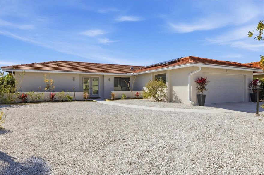 Incredible Value - improvements and upgrades galore in this renovated and updated, 3-bedroom, 2-bath, 2-car garage, split-floor plan Florida-style home with a light, bright open floor plan. This home is ready to move into, featuring a newer 2024 Tile Roof, newer A/C, newer electrical panel, newer hot water heater, New flooring throughout. New kitchen with designer coastal wood cabinetry, granite counters, stainless steel appliances, and an innovative breakfast bar in the breakfast nook. New interior doors, hinges, and French handle locksets. Newly renovated bathrooms featuring new vanities, sinks, and fixtures. New light fixtures and ceiling fans throughout the entire home. New Base Moulding. Fresh paint inside and out. Newer hurricane-rated garage door. Plumbing drains lined in 2025. Newer solar panels are owned outright. Modern double-glass door entryway. Entertaining is a breeze with 30' of sliding glass doors connecting the indoors to the outside spaces. The Primary Bedroom is en-suite with a walk-in closet, and private, renovated bathroom with a new vanity, and tub/shower combo with new tile. This floorplan has no wasted space, and flows easily through the privacy-enhancing pocket door to the guest wing, where you'll find the 2nd and 3rd bedrooms, and an updated guest bathroom. Your spirits lifted as you enter this home and gaze across the expansive great room, past the equally expansive Florida room, and out past the kidney-shaped pool to the large lanai area, and out to your private, tropical oasis backyard. Hurricane-rated garage door. Stoned area next to the driveway for extra parking. X Flood Zone. Beautiful mature landscaping. Note: The public records list this home as having a newer effective year built. Close to beaches, public boat ramps, shopping, restaurants and dining, playhouses, theatres, libraries, recreation centers, parks with playgrounds and walking/biking trails, sports fields and complexes, YMCA's, fitness centers, and medical facilities. Quick and easy access to main roads and highways makes this community in a highly desirable location - a locale that's tucked away in a waterfront community that feels like a vacation getaway, yet so close to so many of Southwest Florida's attractions.