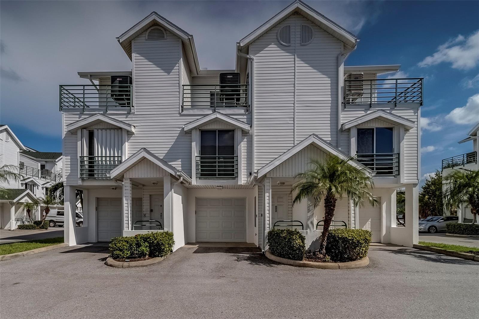 Welcome to 320 Island Way #402—a stunningly remodeled townhome in the heart of Clearwater Beach, where coastal living meets sophisticated design. Every inch of this 3-bedroom plus loft, 3-bath home has been professionally curated with designer finishes, creating a seamless blend of style, comfort, and functionality. Spanning approximately 1,700 square feet, this residence offers an airy open-concept floor plan filled with natural light. The gourmet kitchen features high-end cabinetry, quartz countertops, and premium stainless steel appliances, making it the perfect hub for both everyday meals and entertaining. The adjoining living and dining spaces flow effortlessly, leading to a private balcony ideal for enjoying warm Florida breezes. Upstairs, you’ll find a versatile loft space—perfect for a home office, media lounge, or guest area—alongside the luxurious primary suite. The primary retreat boasts a spa-like bathroom with designer tile work, double vanity, and walk-in shower, plus generous closet space. Two additional bedrooms and beautifully updated bathrooms provide ample comfort for family and guests. This home also includes a private garage for secure parking and extra storage. Outside your door, enjoy the community’s resort-style amenities: a sparkling pool, relaxing spa, and BBQ area for gatherings. Best of all, you’re within walking distance to Florida’s #1 beach, with its sugar-white sands and turquoise waters, as well as vibrant local restaurants, shops, and entertainment venues. Whether you’re looking for a full-time residence, vacation escape, or investment property, this home delivers the best of Clearwater Beach living. Move-in ready and designed to impress—your coastal dream home awaits.