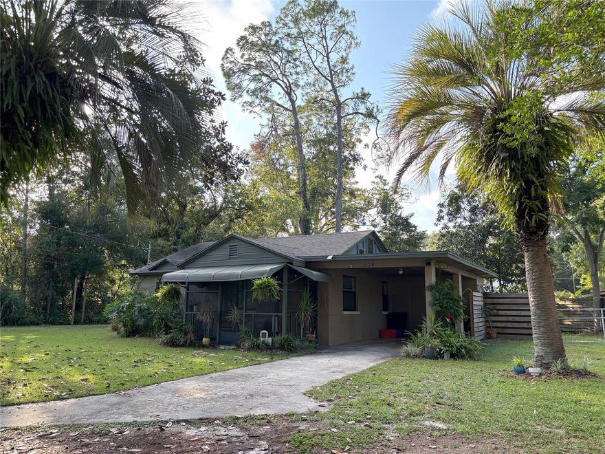 This vintage 1940's Concrete block bungalow proximal to the historic Duckpond area exudes charm and low stress Gainesville living!

Vaulted ceilings upon entry create a spacious front living/dining combination for entertaining and relaxing. Wide-plank Pine floors provide  warm authenticity to this cozy home. The bathroom was renovated in 2020 with a custom tiled walk-in shower, styled in Art deco fashion to replace the original galvanized tub. Plumbing to the bath and kitchen were also updated at this time. 

There are two spacious bedrooms with large windows for great light and ample closets. All rooms have Hunter ceiling fans and windows with screens to allow fresh airy living. 

The kitchen is spacious and well-lit, complete with modern cabinetry a built in microwave, stainless gas range, and refrigerator. Off the kitchen is a bonus climate-controlled Florida room with full wrap around windows, perfect for reading, lounging, or setting up a as an excellent work/guest space. This room flows easily into the lovingly manicured backyard complete with concrete patio, and gated entrance.There is also a solidly constructed and secured storage shed in the backyard! 

Add to that a full size carport connected to the home with more built-in storage and a charming screened in front porch and this home rounds out with thoughtful details that increase the functionality of the square footage. Roof was replaced in 2017, as was the Gas Hot water heater. 

This Home sits on a gorgeous 0.25-acre corner lot, sculpted to be both beautiful and functional. Conveniently located, this home provides easy access to downtown Gainesville, the University of Florida main campus, and NE park and Public pool. Current owners provide a transferrable home warranty through August of 2026 with this property.  Don't miss the opportunity to own in a great neighborhood!