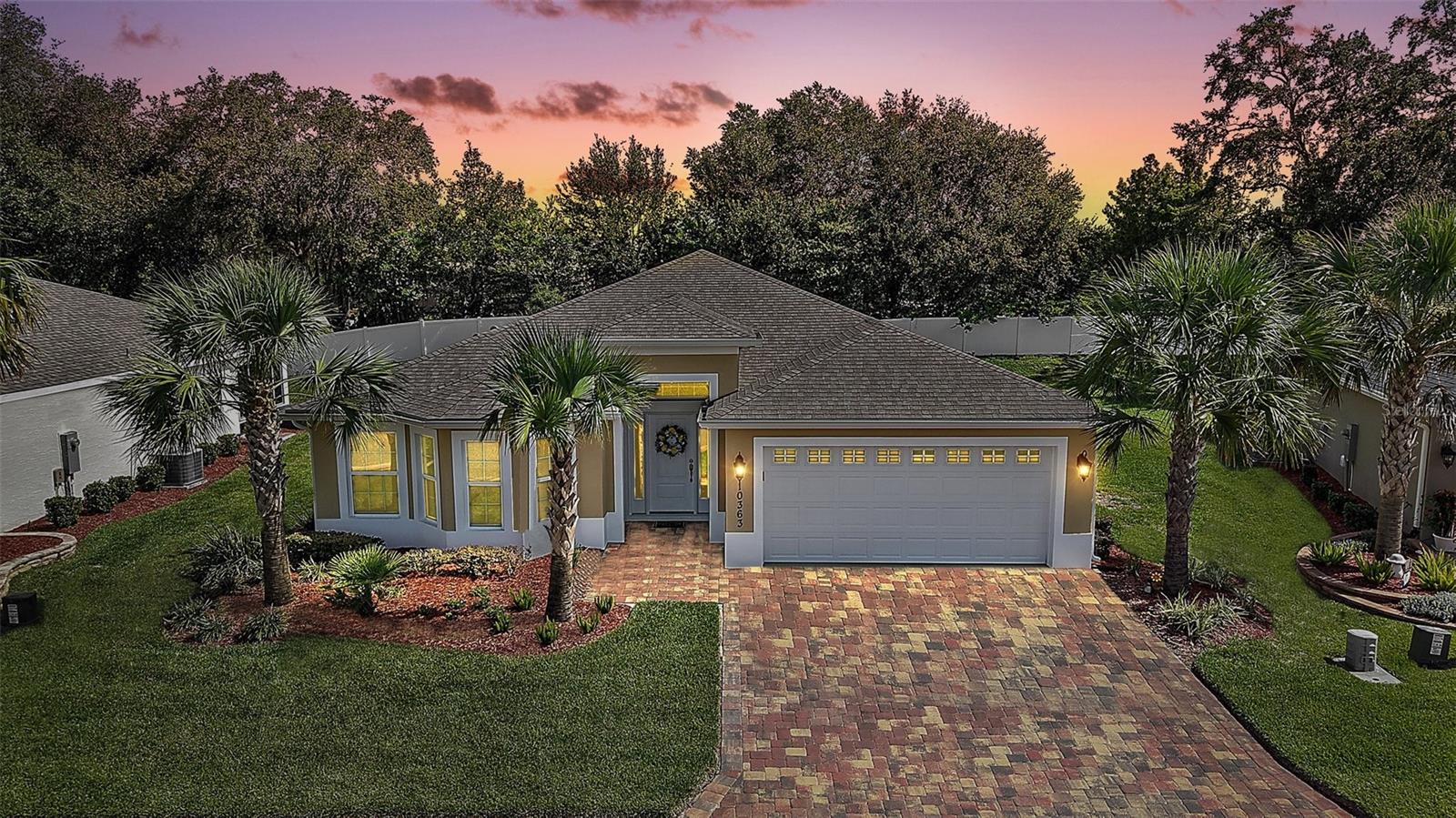 Welcome to this STUNNING 3/2 BLOCK and STUCCO Osprey model, BEAUTIFULLY CRAFTED in 2022 and METICULOUSLY MAINTAINED—featuring an EXPANSIVE yard with rear PRIVACY fence nestled in the Enclave of the highly sought-after GATED community of Lakeside Landings - just minutes from Lake Sumter Landing, County Road 466, and a wealth of shopping, dining, and entertainment! As a BONUS - enjoy a LOW-MAINTENANCE LIFESTYLE with HOA-COVERED lawn care, landscaping, and irrigation. This IMMACULATE home’s exterior boasts MATURE TROPICAL landscaping and GORGEOUS PAVER drive and walkways. Step inside through the quaint ENTRY VESTIBULE into a BRIGHT and EXPANSIVE foyer, where natural light pours in and PLANK TILE flooring flows seamlessly throughout the main living areas. The OPEN-CONCEPT design features VAULTED ceilings and a SPACIOUS layout that connects the living, dining, and kitchen areas for effortless entertaining and everyday living! The ELEGANT kitchen is a chef’s delight, featuring MODERN greige cabinetry with pull-out shelving, veined QUARTZ countertops, STAINLESS STEEL appliances, an EAT-IN breakfast bar, and a PANTRY closet for added STORAGE. From the living room, sliding glass doors lead to the screened lanai—a TRANQUIL space overlooking the EXPANSIVE backyard with a rear PRIVACY fence - perfect for sipping your morning coffee or simply relaxing and enjoying the beautiful Florida weather! The primary suite offers a peaceful retreat with a LARGE WAK-IN closet and a CHARMING, BAY-WINDOWED sitting area- the ideal spot to cozy up with a good book! It’s LUXURIOUS en-suite bathroom showcases DOUBLE sinks with QUARTZ countertops, greige cabinetry, a TILED WALK-IN shower, and a PRIVATE water closet. A SEPARATE guest wing, discreetly tucked behind a POCKET DOOR at the back of the home, includes two additional bedrooms and a full bathroom. Bedroom two features double windows and a built-in closet, while bedroom three offers a WALK-IN closet and flexibility as a guest room or home office. The guest bathroom is thoughtfully designed with QUARTZ counters, greige cabinetry, a TILED tub/shower combo, and a hallway LINEN closet. CONVENIENTLY LOCATED near the kitchen is an INTERIOR LAUNDRY closet. The two-car garage offers painted floors and PLENTY of room for parking and ADDITIONAL STORAGE! The AMAZING Lakeside Landings community boasts INCREDIBLE AMENITIES!!! Indulge in relaxation as you soak up the sun or take a refreshing dip in the FABULOUS RESORT-STYLE POOL and SPA - one of the LARGEST IN THE AREA! Sports enthusiasts will also love the PICKLE BALL and TENNIS courts! The SPACIOUS CLUBHOUSE boasts a FITNESS CENTER and MULTIPLE banquet/meeting ROOMS. There’s even a PLAYGROUND and BEACH AREA with access to BEAUTIFUL Lake Miona! This PHENOMENAL COMMUNITY is CONVENIENTLY LOCATED directly off of CR 472 (Rainey Trail) between US 301 and Buena Vista Blvd in The Villages. JUST MINUTES from Lake Sumter Landing, the Villages Charter Schools, and CR466 offering easy access to an ABUNDANCE of shopping, dining, banking, medical and more! DON’T MISS YOUR OPPORTUNITY TO MAKE THIS FABULOUS HOME in an AMAZING LOCATION YOUR OWN! Please watch our walkthrough video and call today to schedule your Private Showing or Virtual Tour!