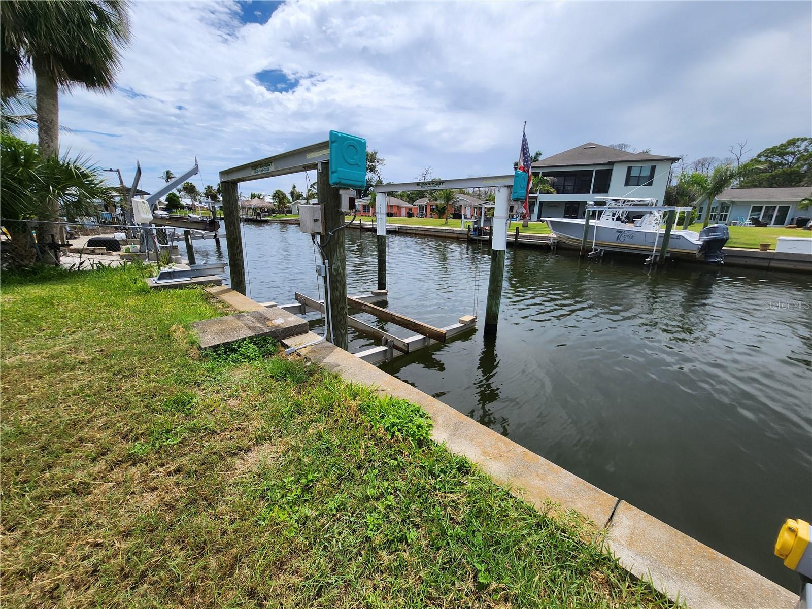 Deep Water Gulf Access – No Bridges!
This choice seawalled lot offers direct and unobstructed deep-water access to Lemon Bay and the Gulf of America—no bridges! Enjoy quick and easy boating access right from your backyard.
Electric and water have already been run to the concrete seawall and wooden dock. A 13,000 lb boat lift is fully operational and ready for your vessel.
The existing home was damaged in the last hurricane and has been fully gutted, providing a blank slate for your custom finishes. Whether you're looking to renovate or rebuild, the potential is here.
The detached garage has solid structure and can be used for storage or easily converted into an oversized laundry room or workshop.
This is a great opportunity to create your ideal waterfront retreat—whether you renovate the existing structure for a rental or vacation home, or tear down and build your dream home on the water.
