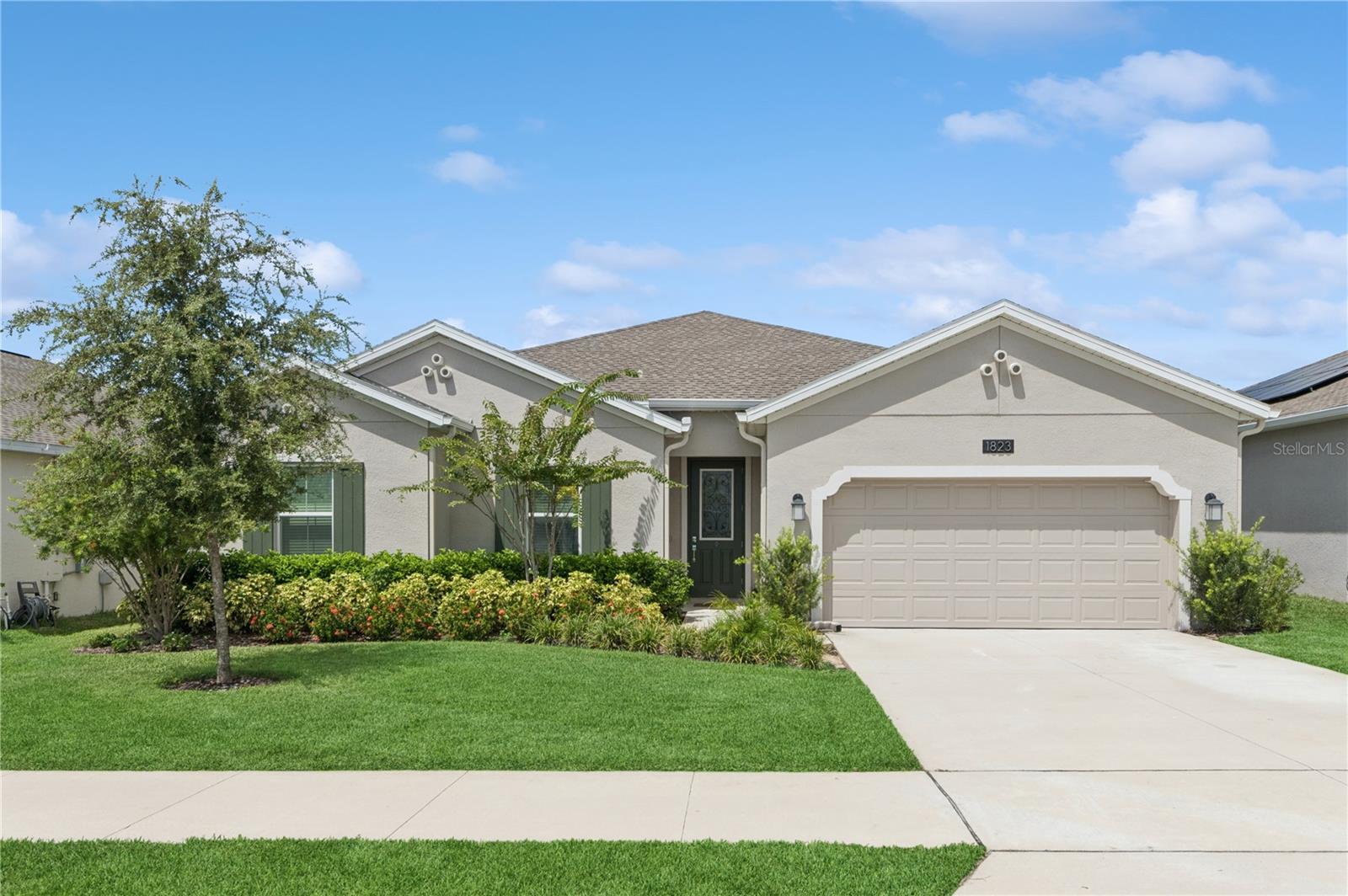 Discover unparalleled elegance in this signature residence within the Trinity Lakes Community of Groveland, FL. Beautiful as its name suggests, the Bonita II, built in 2023, showcases expansive, light-filled interiors and premium craftsmanship throughout its 2,447 square feet of thoughtfully appointed living space. This distinguished and only Pool home on the market offers 3 generously proportioned bedrooms and 2.5 impeccably designed bathrooms, harmonizing luxury, comfort, and sustainability.
Upon entering, you are greeted by soaring tray ceilings and an open-concept floor plan that gracefully guides you to the spa-inspired owner’s suite. This sanctuary features dual vanities, a spacious walk-in shower, a separate soaking tub, and an expansive walk-in closet. The gourmet kitchen, designed for both elegance and functionality, boasts Quarts countertops, stainless-steel energy-efficient appliances, a luminous eat-in area, and abundant storage—ideal for both culinary pursuits and fun entertaining.
The residence effortlessly transitions to the outdoors through double sliding patio doors opening to a serene screened lanai, overlooking a meticulously maintained totally fenced yard. The outdoor living space is further enhanced by a sparkling new Pool that is illuminated for evening use, a sun tanning area, brand-new pavers and vibrant tropical landscaping featuring mature palms and lush greenery. The yard also includes a dog run, open green space, and a play area, offering a perfect blend of privacy and versatility.
Additional amenities include a first-floor laundry room complete with washer and dryer, and an oversized 3-car tandem garage, providing exceptional storage and flexibility—whether for a workshop, home office, or fitness studio. This 2023-built home is equipped with solar panels, energy-efficient appliances, and comprehensive smart home connectivity to ensure optimal comfort, convenience, and cost savings.
Residents of Trinity Lakes enjoy access to premier community amenities, including a resort-style clubhouse and pool, a state-of-the-art fitness center, playgrounds, and a lake community park with a dock. Conveniently located just 35 minutes from Orlando International Airport and near Lakeridge Winery, with effortless access to Florida’s Turnpike, Highway 50, Highway 19, and Highway 27, this address affords a refined lifestyle with unmatched convenience to both Clermont, Minneola and Orlando.
Beyond the community, Groveland offers a captivating blend of outdoor adventure and small-town charm. Spend a relaxing day at Lake David Park, where you can enjoy fishing, kayaking, or even a visit to the skate park. Golf enthusiasts will appreciate the proximity to Green Valley Country Club, while nature lovers can explore the breathtaking beauty of Lake Louisa State Park, just a short drive away. Whether you prefer to hike, bike, kayak, or camp, Groveland places you right in the heart of Central Florida’s natural landscape.
From its refined interior to its resort-style backyard and idyllic location, the Bonita II truly lives up to its name—a residence of Beauty, comfort, and distinction. Schedule your private tour today and experience the pinnacle of premium Florida living.