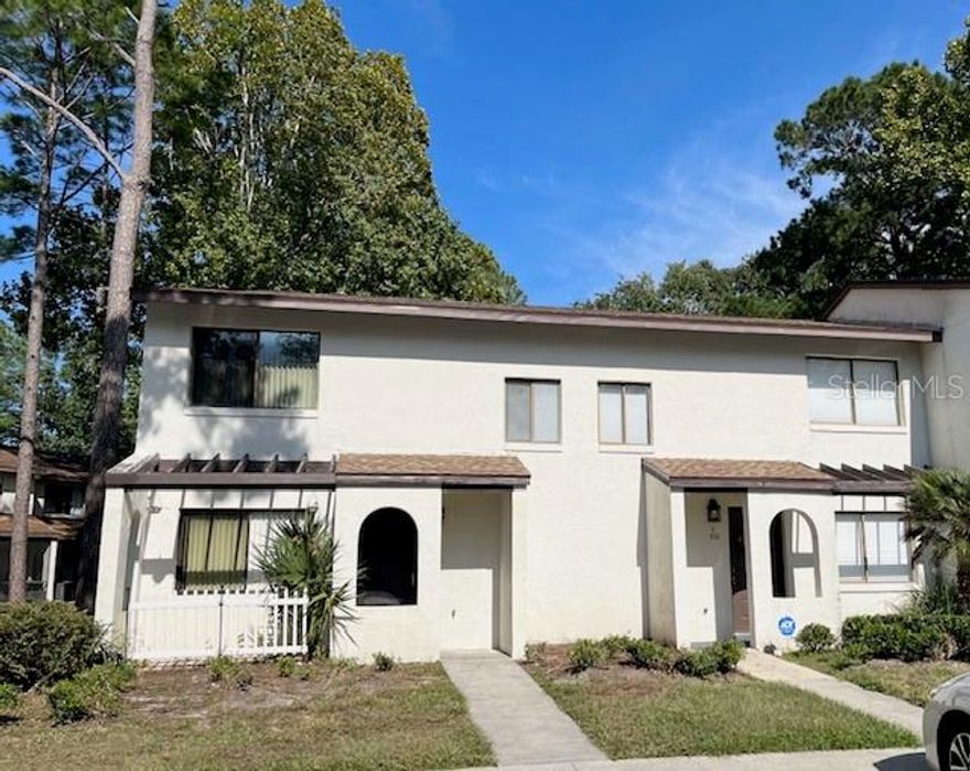 Don't miss this exceptional corner unit townhouse located in the desirable SW side of Gainesville, perfect for both families and investors. This well-maintained unit boasts 3 good size bedrooms and 2.5 updated bathrooms, offering a convenient first-floor bedroom and half bath, as well as two additional bedrooms and two full bathrooms on the second floor. The living/dining room and updated kitchen, complete with stainless steel appliances and newer countertops, make it ideal for entertaining. Main living areas and bathrooms are tiled, and beautiful dark laminate in all bedrooms. Additional amenities include a laundry closet equipped with washer and dryer, a relaxing screened-in porch, and a community pool just steps away across the parking lot. Roof was just replaced 2 weeks ago and Water Heater replaced in 2022. With a bus line that stops directly in front of complex, enjoy easy commutes to the University of Florida, Butler Plaza and Celebration Pointe, and a multitude of dining and entertainment options.