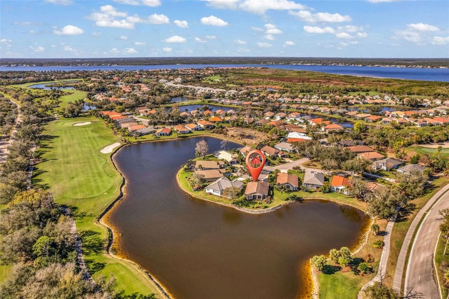 Under contract-accepting backup offers. Water and golf course views take center stage in this Riverwood home, perfectly positioned on a premium waterfront tip lot overlooking the 10th hole. With a new roof in 2022, a new AC in 2023, and a beautifully updated kitchen completed in 2021, this property pairs stunning scenery with meaningful improvements. Tucked at the end of a cul-de-sac along one of Village Lane’s picturesque tree-lined streets, the setting provides privacy and beautiful curb appeal, enhanced by lush, established landscaping and an extended driveway. Inside, high-volume ceilings and large windows fill the space with natural light, highlighting the open floor plan and drawing your eye straight to the water. Transom windows above the sliding glass doors brighten the great room, and the living area opens to a covered, tiled, screened lanai designed for true Florida outdoor living, where morning coffee and evening gatherings are framed by sweeping water and golf course views. The kitchen is bright and cheerful with wood cabinetry, quartz countertops, a breakfast bar, and a sunny breakfast nook just off the main space. A separate den provides flexible space for a home office or additional guest area, and the laundry room includes extra storage and a utility sink. Located close to the clubhouse and activity center, this home combines exceptional views with a prime setting within the community, and a transferable flood policy is in place. As part of the vibrant Riverwood community, residents enjoy a par-72 championship golf course with optional membership, along with a state-of-the-art fitness center, a resort-style pool, pickleball courts, and Har Tru tennis courts. Beyond the gates, you will find easy access to world-class fishing, boating, waterfront dining, shopping, and the beautiful sandy beaches of the Gulf, conveniently located between Sarasota and Fort Myers on Florida’s West Coast. If you’ve been waiting for one of Riverwood’s special waterfront locations with both water and golf course views, this one is ready to welcome you home.