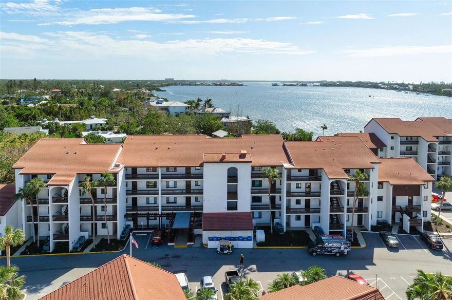 Exceptional and enchanting, this seaside condo is a hidden jewel on the bay, providing a direct intracoastal water view. It serves as the perfect gateway to Siesta Key, radiating all the coastal vibes and relaxed elegance of coastal living. As you step inside, you're immediately greeted by an airy ambiance, thanks to the high ceilings and open floor plan. The generous natural light pours in, creating a welcoming atmosphere, inviting you to express your creativity for a beach inspired theme. This condo features an expansive open floor plan that seamlessly extends to the lanai, which serves as additional living space. Here, you can indulge in endless views of the bay, where you might catch glimpses of dolphins playing and enjoy the tranquil charm of the gulf-all from the comfort of your home. This remarkable condo is a must see, not only for its stunning view, but also for the exceptional community amenities that enhance the Florida lifestyle experience. Residents can unwind at two inviting pools; store their kayaks for quick access to the waterways and engage in a friendly match on the tennis court. A leisurely stroll or bike ride leads you to the world-renowned Siesta Key beach, where powdery sands and azure waters invite you to bask in the sun. Close proximity to boating, jet ski rental, dining, and shopping options.