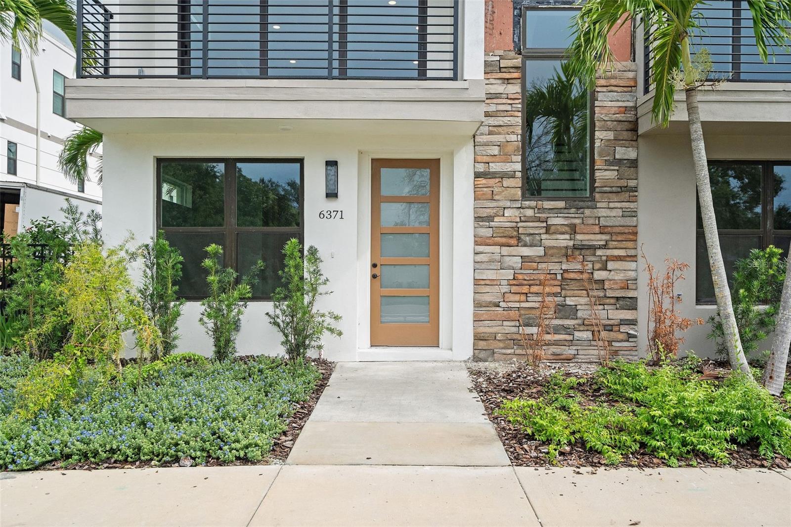 Move-in ready and thoughtfully designed, this corner residence at Strum Place offers modern living within a secure, gated townhome community in St. Petersburg. Featuring 3 bedrooms and 3.5 bathrooms, the layout includes a versatile first-floor suite that can function as a home office, guest quarters, or private studio. A rare find, this corner unit comes complete with an installed elevator, ensuring effortless access to all levels. The main living floor impresses with 10’ ceilings, wood flooring, abundant natural light, and a striking open stairwell with wood treads and metal railings. The chef’s kitchen is finished with custom wood cabinetry, quartz countertops, a walk-in pantry, and remium
KitchenAid appliances—including a double oven. Upstairs, the primary suite offers a spa-inspired bath with dual vanities, porcelain tile, and an oversized walk-in glass shower. A dedicated laundry room with sink and hookups sits conveniently on the same level. Additional features include a two-car garage with extra storage, impact-resistant windows and doors, and pre-wiring for internet and media. Community amenities include secure entry, guest parking, and professional landscaping. Strum Place delivers a seamless blend of comfort, accessibility, and contemporary style—an exceptional opportunity in one of St. Petersburg’s most desirable settings.