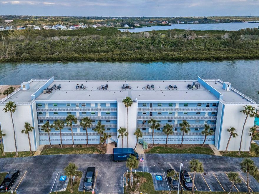 Your Private Island Retreat Directly on the Intracoastal Waterway awaits in this exclusive, 36-residence waterfront enclave with a wonderful waterfront Community inground heated pool and steps to the sugary sands of the Gulf, in serene Redington Shores. Perfectly positioned on the Intracoastal Waterway, Portside Condos offers an extraordinary vantage point with unobstructed panoramic views across the waterway from a pristine nature preserve, while the sugar-white sands of the Gulf of Mexico lie just steps away. This rare setting delivers the ultimate coastal luxury; Intracoastal sunrises from your balcony, Gulf sunsets from the front porch, and a lifestyle defined by water in every direction. This spacious, light filled 2BR, 2BA, 1,250 SF residence invites you to reimagine its generous spaces into a refined coastal haven. Inside, soothing water views, gentle bay breezes, and natural light create an atmosphere of effortless relaxation. The private waterfront balcony becomes an evening sanctuary—perfect for watching the shimmer of passing boats and savoring the quiet exclusivity of this intimate community. A highly sought-after under-building parking space can be secured with the condo for an additional consideration (the unit does not include one currently). The grounds are wrapped in lush tropical landscaping, and the heated waterfront pool offers a resort-style escape just steps from your door. The waterfront primary suite features a spacious walk-in closet and en-suite bath with an additional vanity. The open living and dining areas flow seamlessly to the balcony, while the efficient kitchen provides ample cabinetry and counter space along with a breakfast bar that allows the cook to be part of all gatherings. A charming eat-in kitchen area adjacent to the kitchen captures Gulf breezes and sunset colors from the west-facing porch. A generous guest suite (second bedroom), inside laundry with full-size washer and dryer, and thoughtful storage complete the home. Some value added Community upgrades following the storms include a newer roof (2 years), New pool equipment, pump, heater and fencing, new exterior paint & weather proofing, walkways and balconies resealed with gemstone, new elevator, generator, electrical meter bases (newer breaker box in the unit too), new sidewalks & drainage for side yards, renovated lobby and entry ceiling replaced just to name a few recent improvements! Frequent visits from manatees and dolphins, a tranquil beach-town setting, and the boutique scale of the community create a truly luxury coastal sanctuary. With pet-friendly policies and a 1-month minimum lease, this residence offers exceptional flexibility for full-time Gulf-coast living, a refined second-home escape, or an investment opportunity.