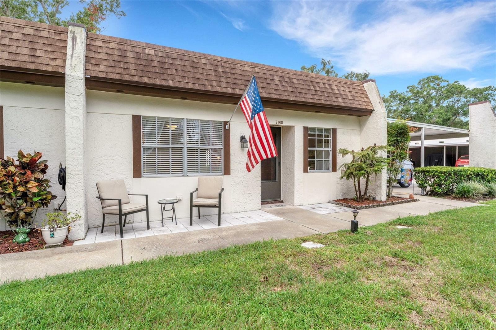 This END UNIT with 2 BEDROOMS, 2 FULL BATHS condo that includes a COVERED CARPORT with STORAGE LOCKER (large enough for bikes, kayak, or decorations) PLUS a FLORIDA ROOM that looks over Green Space that extends your living space beyond the 866 sq ft under air. The home features Light colored, wood-like Laminate flooring, AN INSIDE LAUNDRY CLOSET, plus a DISHWASHER and a BUILT-IN MICROWAVE in the kitchen. The kitchen with plenty of counter space and storage cabinets overlooks the Dining area and has a large window that brings in natural light. Updates also include a NEW ELECTRICAL PANEL in 2020, HVAC in 2019, New Ceiling Fans throughout, and it has been painted with pleasing, neutral colors that will go with any decor. Being Sold Furnished or Unfurnished. The Mission Grove Community has its own pool, shuffleboard, pool pavilion, and laundry facilities. The $674 monthly HOA fee covers the building insurance, the roof, cable, internet, water, sewer, trash, and ground maintenance, giving you the freedom to come and go as you please. The $164 monthly HOA fee gives you the "BIG CLUB" with GOLF with NO GREEN FEES on 3 executive courses, FREE Boat or RV Storage on a secured lot, 2 Heated POOLS, Ceramics, Stained glass, Woodworking workshops, Card games, Board Games, Shows, 2 PONTOON boats for cruising Lake Tarpon, just to name a few. Highland Lakes on Lake Tarpon, where Relaxation and Recreation come together in this "55 or better" community. Convenient to shopping, quaint downtown Palm Harbor, the Beaches: Honeymoon Island, Sunset Beach, Fred Howard and Clearwater Beach, 2 International Airports, the perfect place for the full-time resident or a seasonal home.